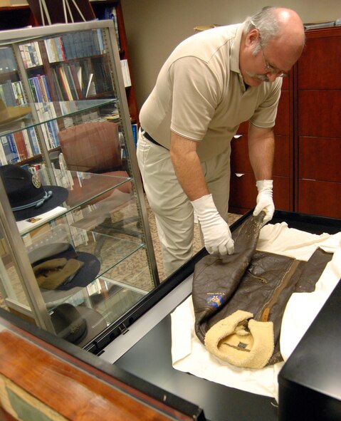 LAUGHLIN AIR FORCE BASE, Texas – Todd Schroeder, 47th Flying Training Wing historian, displays 2nd Lt. Jack Thomas Laughlin’s nearly 70 year-old cold weather flight jacket here Aug. 4. The base was named after Lieutenant Laughlin, a Del Rio native, who was killed over Java in the South Pacific during the early days of World War II. Mr Schroeder’s job as the wing historian is to preserve and record history, ensuring Laughlin and Air Force members can look back and find any information needed for years to come. (U.S. Air Force photo by Airman 1st Class Sara Csurilla) 