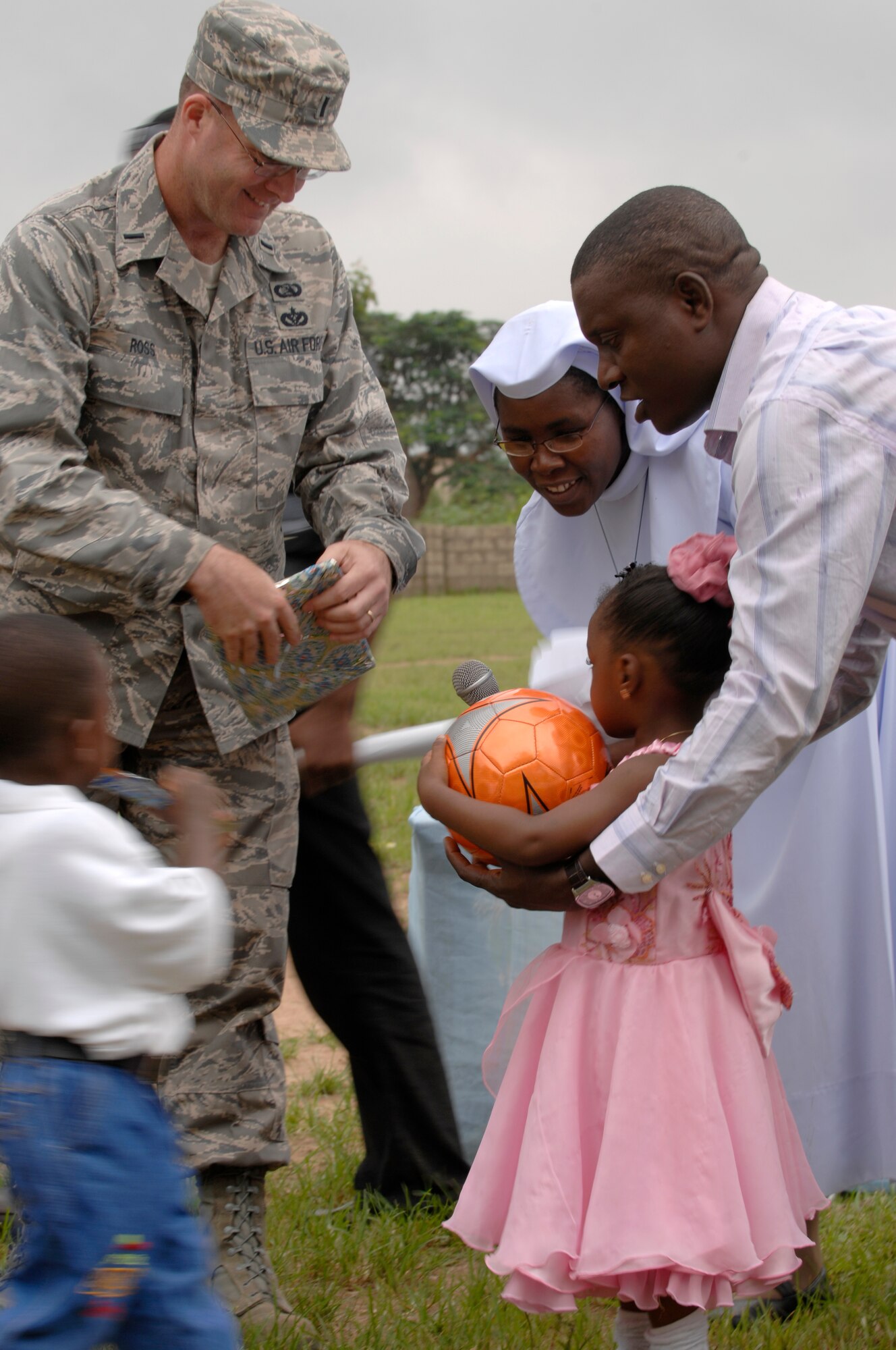 U.S. Air Force 1st Lt. Keith Ross, 1st Combat Communications Squadron, left, and  Sister Tina of St. Therese Primary school, right, hand-out soccer balls to the top ten performers of the school July 17, 2008 St. Therese Primary school, Bwari. 1st Lt. Ross brought the balls to give out to children in between participating in the Africa Endeavor Exercise. AE-08, a U.S. European Command-sponsored exercise, brings the U.S. and African nations together to plan and execute interoperability testing of command, control, communications and computer systems from participant nations in preparation for future African humanitarian, peacekeeping and disaster relief operations. (U. S.  Air Force photo by U.S. Air Force Airman 1st Class Nathan Lipscomb) (Released)