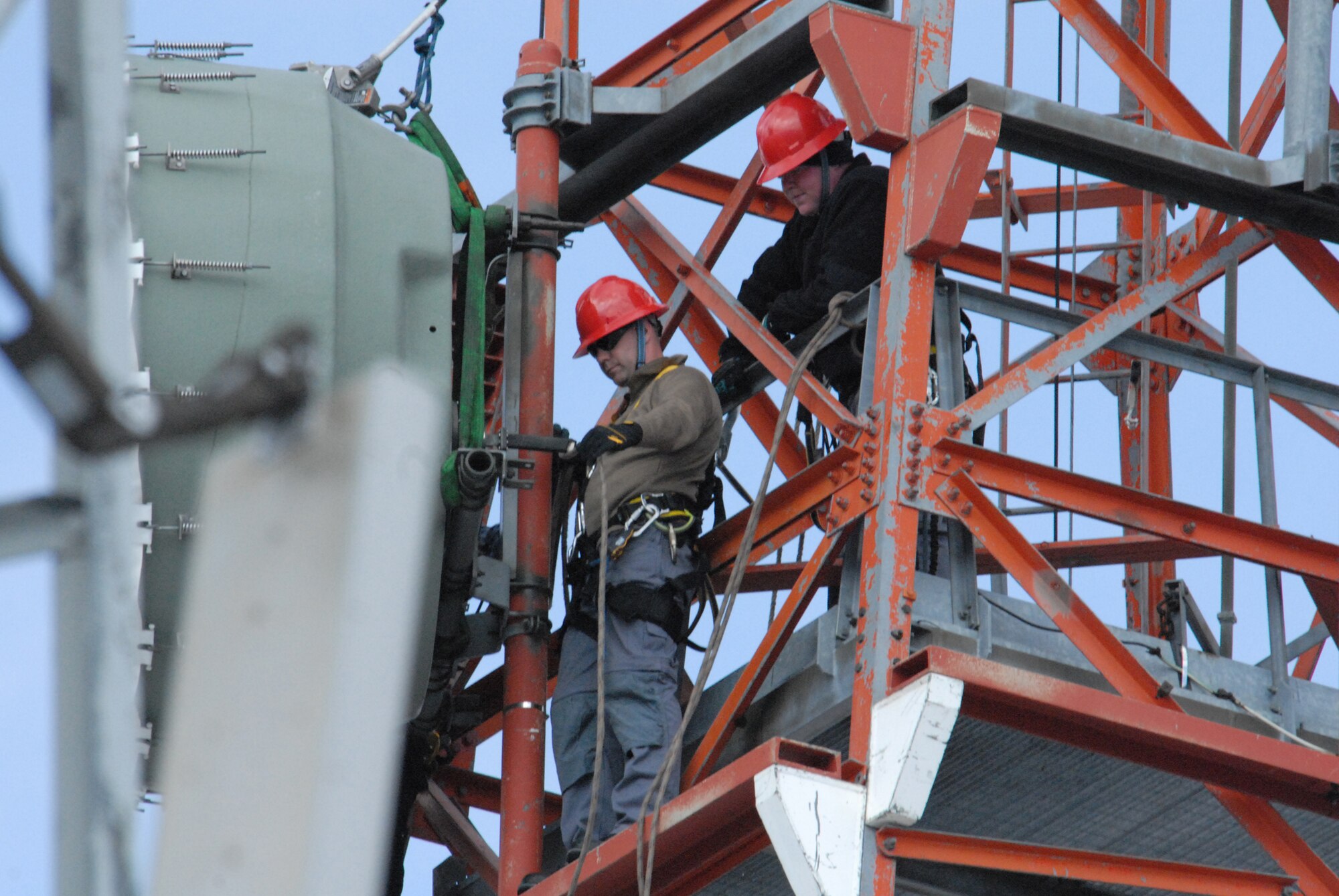 Staff Sgt. Matt Pearson, 1st Communications Maintenance Squadron, instructs Maj. Mike Phillips, 1st CMXS commander, how to secure a dish before lowering it to the ground. (Courtsey photo)