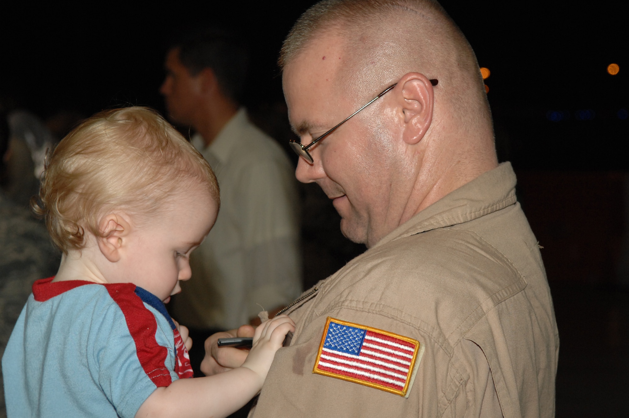 Tech. Sgt. James Buster, 16th Special Operations Squadron, spends some quality time with his grandson Riley during the Operation Homecoming celebration which started at 1:30 a.m. Aug. 5. Sergeant Buster was one of the nearly 200 Airmen who were welcomed home from their deployments during the ceremony. (U.S. Air Force photo/Senior Airman Stephanie Jacobs)