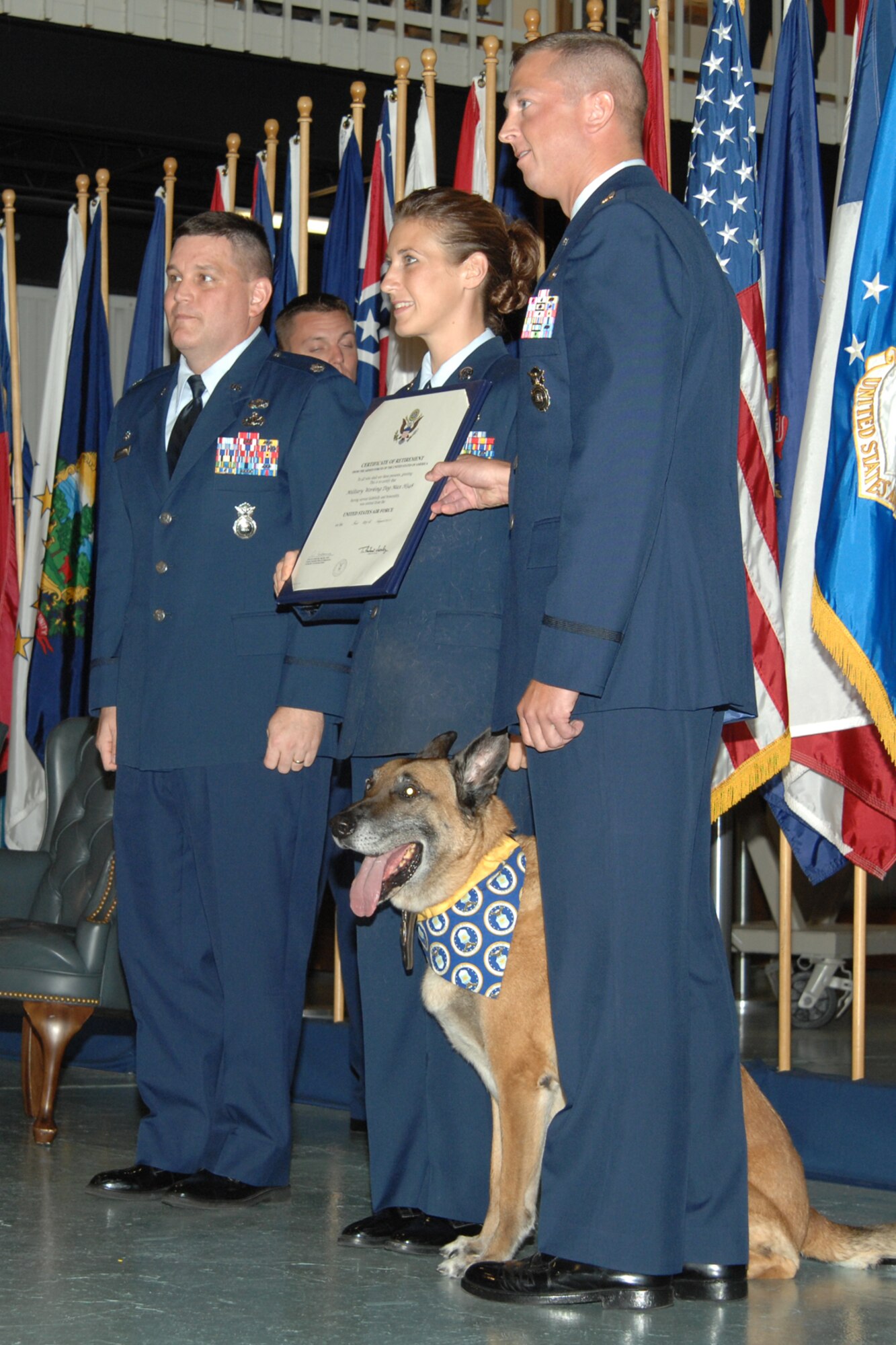 The retirement certificate for Marco, a military working dog with the 1st Special Operations Security Forces Squadron, is presented to Tech. Sgt. Rebecca Lind, a dog handler with the 1st SOSFS, Aug. 1 at the Air Armament Museum. Marco, who has been at Hurlburt Field since March 2005, was retired and adopted by Sergeant Lind. (U.S. Air Force photo/Senior Airman Stephanie Jacobs)