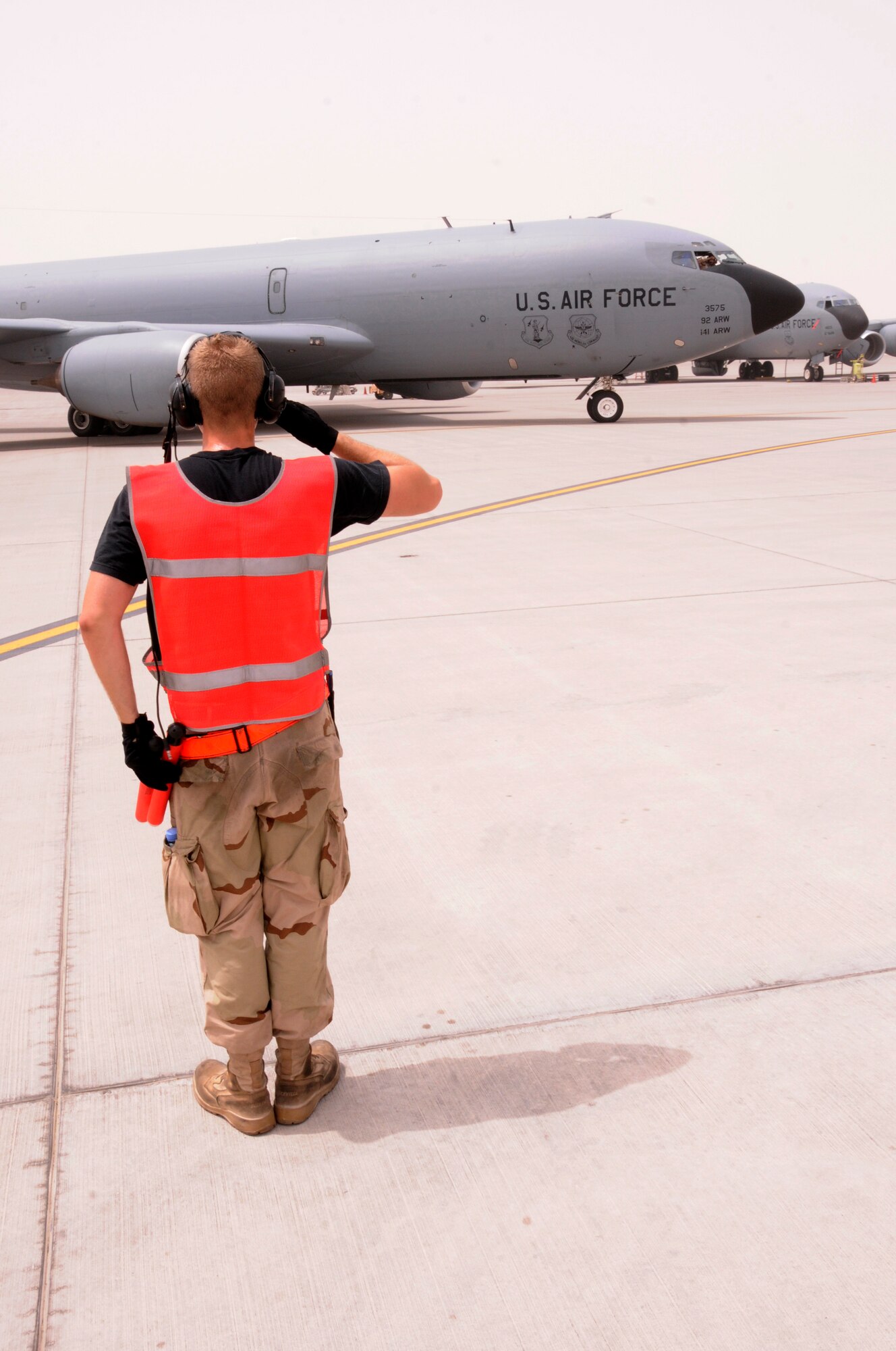 Airman 1st Class Derek Larue, assigned to the 340th Expeditionary Aircraft Maintenance Squadron from Grand Forks Air Force Base, N.D., salutes a KC-135 he has just marshaled out of its parking spot here at an undisclosed location in Southwest Asia Aug. 3, 2008.  Members of the 340th launch, recover and perform maintenance on the KC-135 aircraft which refuels all types of bombers, fighters and other support aircraft engaged in Operations Iraqi Freedom, Enduring Freedom and Combined Joint Task Force Horn of Africa..  (U.S. Air Force photo by Tech. Sgt. Michael Boquette/RELEASED)