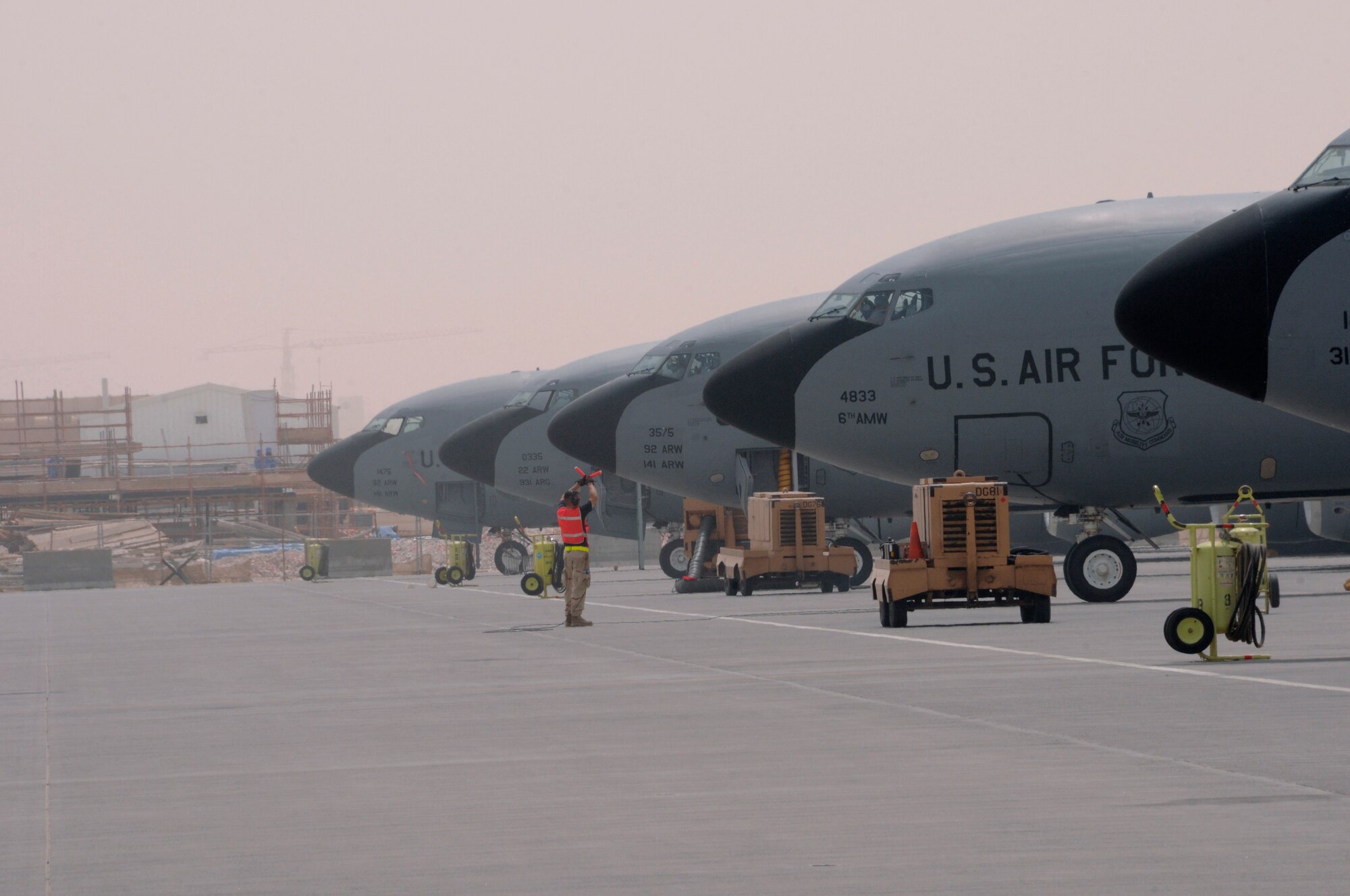 Tech. Sgt. Jim Erickson, a crew chief with the 340th Expeditionary Aircraft Maintenance Squadron from Grand Forks Air Force Base, N.D., marshals a KC-135 to a stop upon completion of a refueling mission Aug. 3, 2008, at an undisclosed location in Southwest Asia.  The 340th refuels all types of bombers, fighters and other support aircraft engaged in Operations Iraqi Freedom, Enduring Freedom and Combined Joint Task Force Horn of Africa.  (U.S. Air Force photo by Tech. Sgt. Michael Boquette/RELEASED)