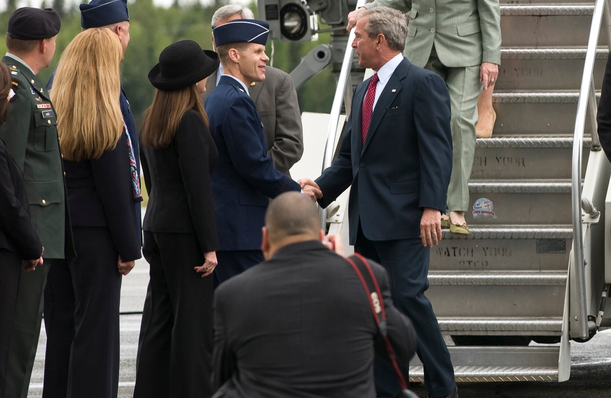 President George W. Bush is greeted by Brig. Gen. Mark Graper, 354th Fighter Wing commander as he exit Air Force One August 4, 2008 at Eielson Air Force Base, Alaska. The President made a short stop at Eielson during his trip to the 2008 Olympic Games being held at Beijing, China. During his time here he had a chance to talk to a crowd of over 2,000 military personnel and taking the time to shake hands and thank them for their service. (U.S. Air Force photo by Airman 1st Class Jonathan Snyder)