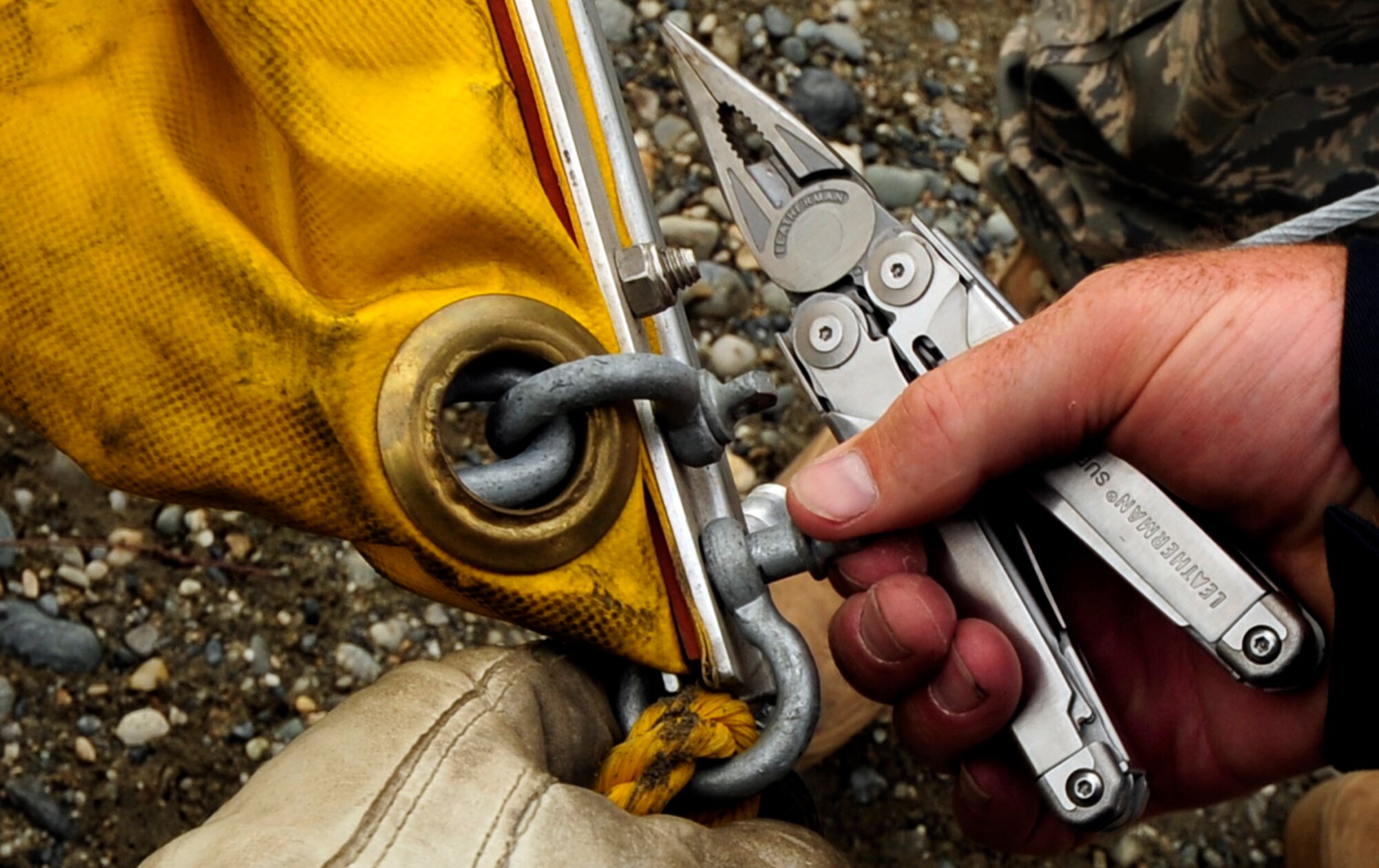 Mr.Scott Caple, a U.S Navy Supervisor of Salvage Mechanic Operator ensures the connection of a contamination boom is set propererly prior to an oil and light fuels spill water contamination clean-up exercise July 23, 2008 at Eielson Air Force Base, Alaska . This exercise is an annual requirement based on the Oil Pollution Act of 1990. (U.S Air Force Photo by Tech Sgt Eric T. Sheler)