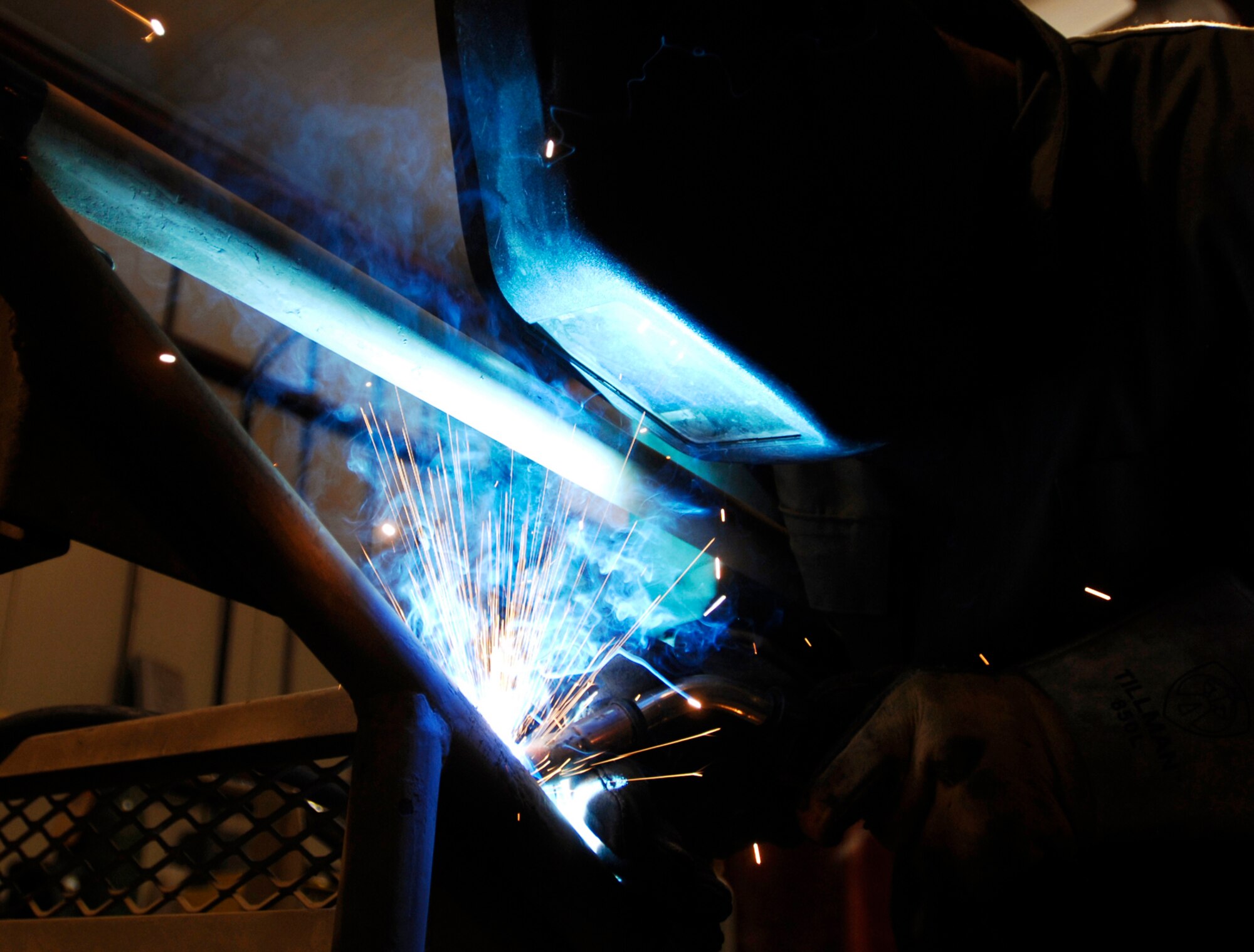 JOINT BASE BALAD, Iraq -- Senior Airman Joseph Krafchak uses an arc welder to repair an aircraft maintenance stand here Aug. 2. Aircraft maintainers use the stands to perform maintenance on F-16 Fighting Falcons. Airman Krafshak, a metals technician journeyman with the 332nd Expeditionary Maintenance Squadron here, is deployed from Shaw Air Force Base, S.C. His hometown is Lompoc, Calif. (U.S. Air Force photo/Airman 1st Class Jason Epley) 