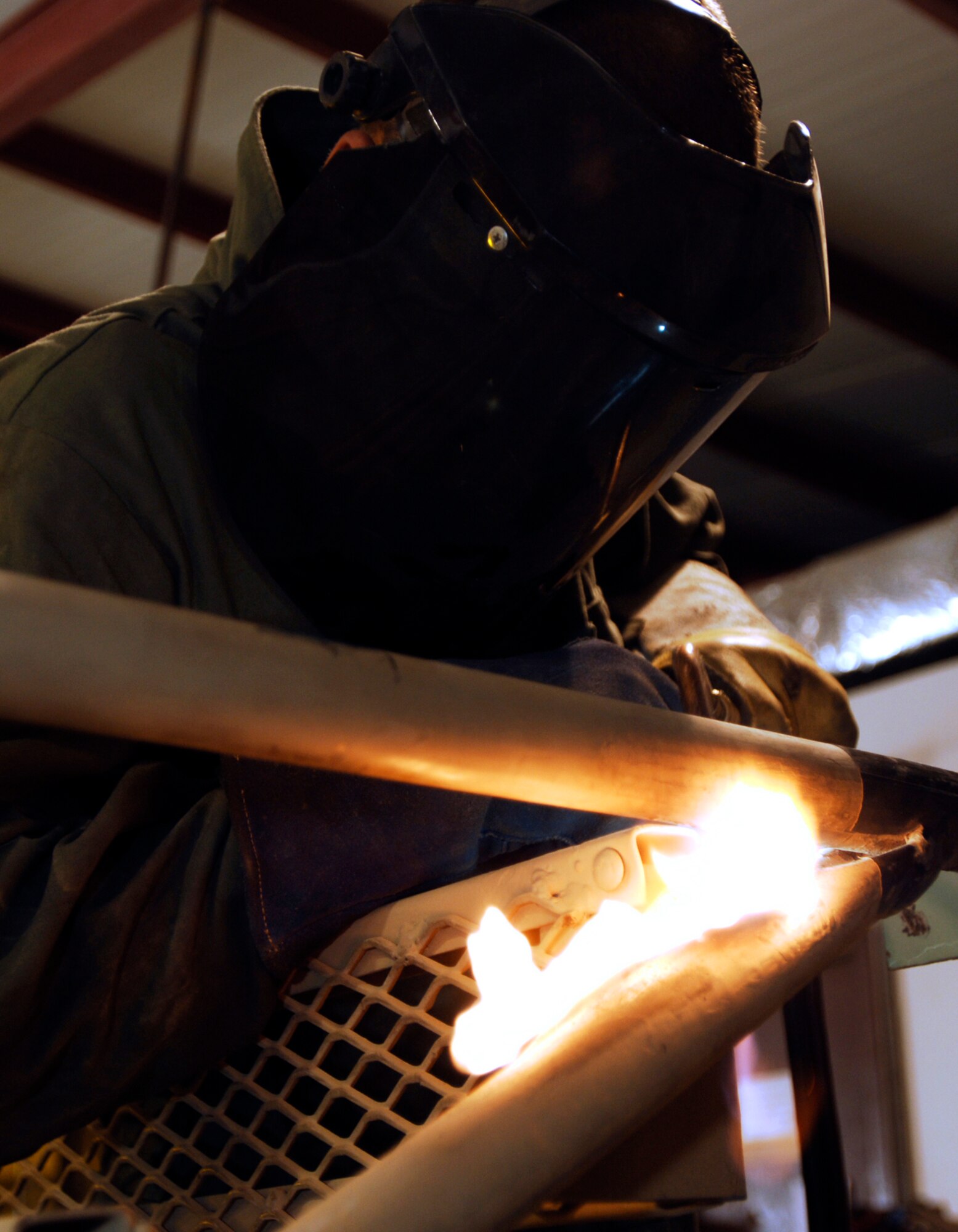 JOINT BASE BALAD, Iraq -- Senior Airman Joseph Krafchak uses an acetylene torch to repair an aircraft maintenance stand here Aug. 2. Aircraft maintainers use the stands to perform maintenance on F-16s. Airman Krafshak, a metals technician journeyman with the 332nd Expeditionary Maintenance Squadron here, is deployed from Shaw Air Force Base, S.C. His hometown is Lompoc, Calif. (U.S. Air Force photo/Airman 1st Class Jason Epley)