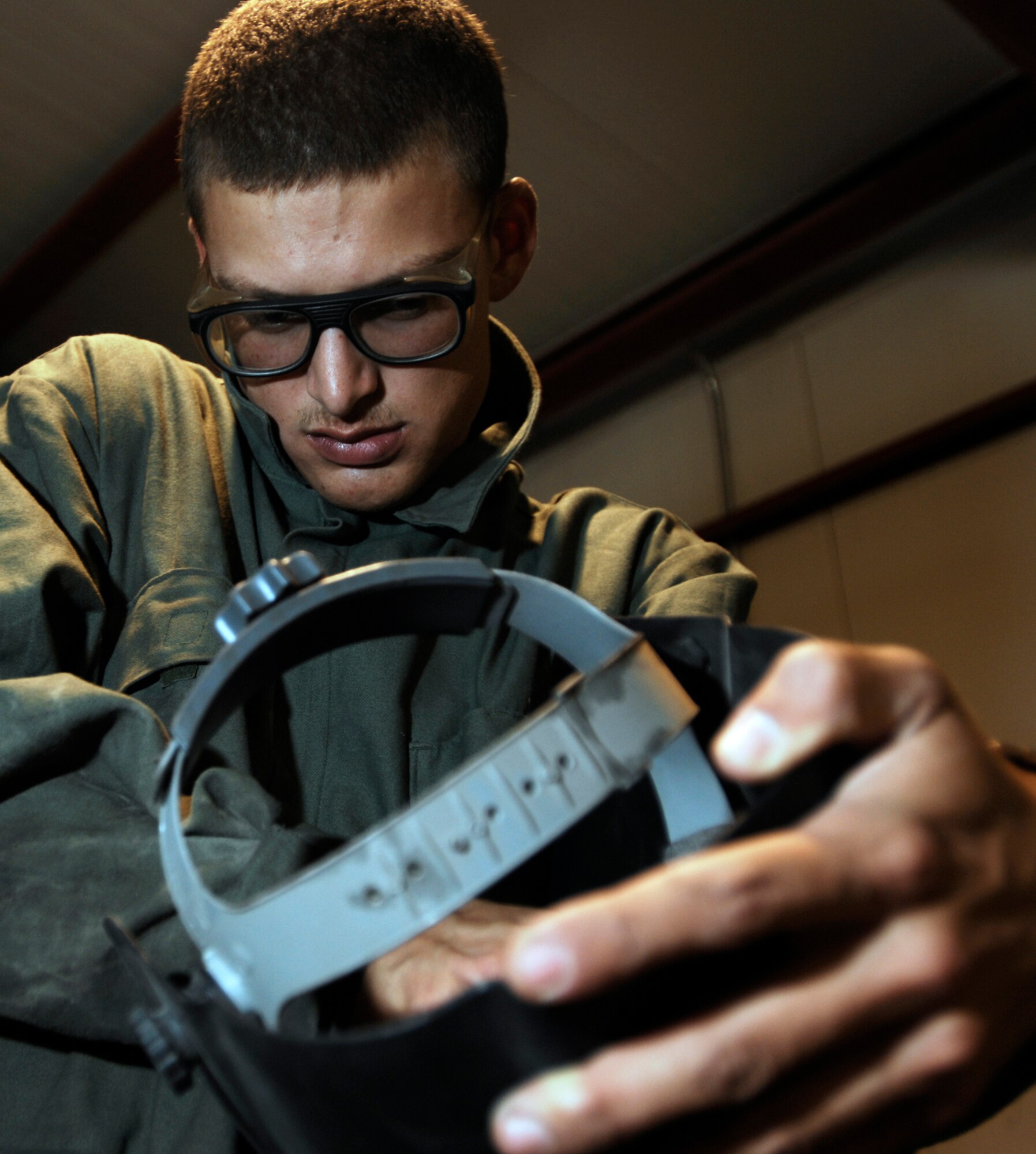 JOINT BASE BALAD, Iraq -- Senior Airman Joseph Krafchak turns on a welding helmet before repairing an aircraft maintenance stand here Aug. 2. The helmet protects the user?s eyes automatically in response to the bright light emitted from welding. Airman Krafshak, a metals technician journeyman with the 332nd Expeditionary Maintenance Squadron here, is deployed from Shaw Air Force Base, S.C. His hometown is Lompoc, Calif. (U.S. Air Force photo/Airman 1st Class Jason Epley)