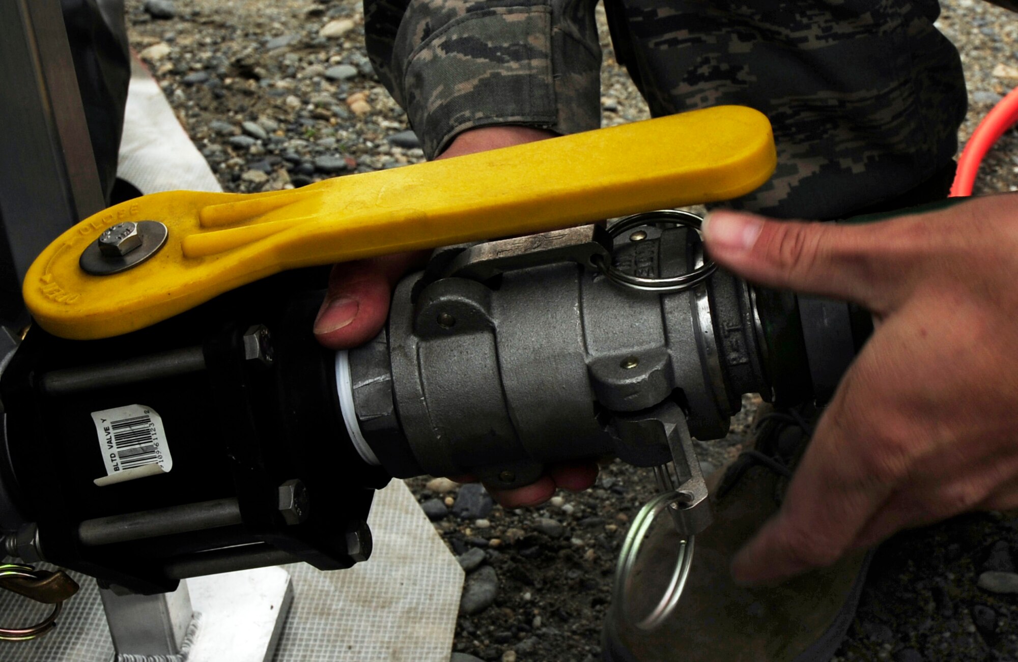 One major part of the assembly of a fast tank is the connection of the discharge hose. The discharge hose is the system in which hazardous substances are removed from a body of water to the fast tank. This discharge hose is connected to a fast tank in preparation for a oil and light fuels spill water contamination clean-up exercise July 23, 2008 at Eielson Air Force Base, Alaska . A fast tank is a collection point where any oil and light fuel that has been cleaned out of water is placed. This exercise is an annual requirement based on the Oil Pollution Act of 1990. (U.S Air Force Photo by Tech. Sgt. Eric T. Sheler)