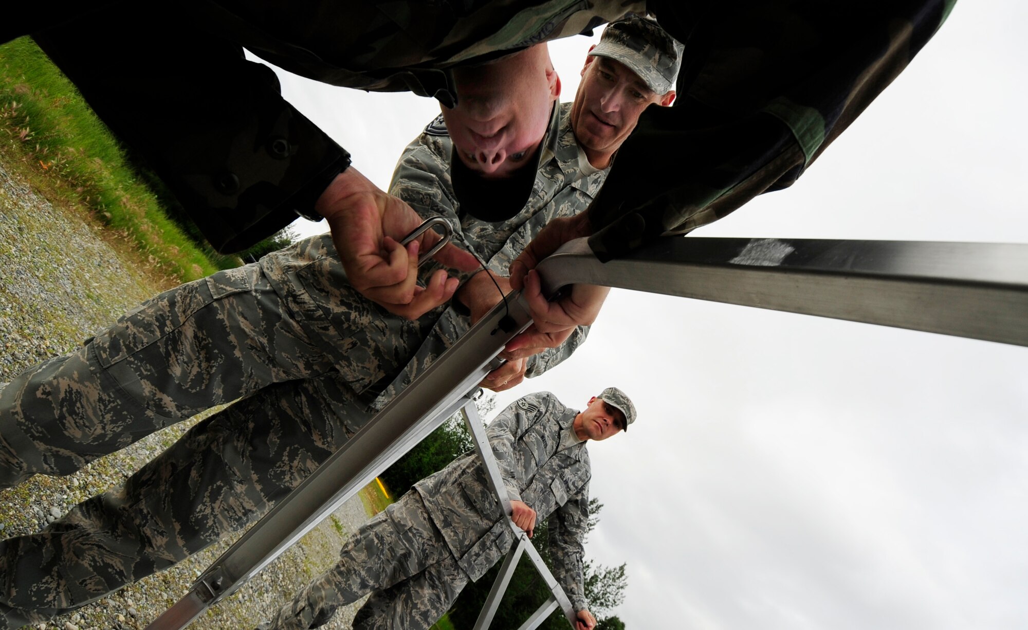 354th Civil Engineer Squadron members Tech. Sgt. Scott Giannelli and Master Sgt. Chris Burroughs assemble the outer structure of a fast tank in preparation for a oil/light fuels spill water contamination clean-up exercise July 23, 2008 at Eielson Air Force Base, Alaska. A fast tank is a collection point where any oil/light fuel that has been cleaned out of water is placed. (U.S Air Force Photo by Tech. Sgt. Eric T. Sheler)