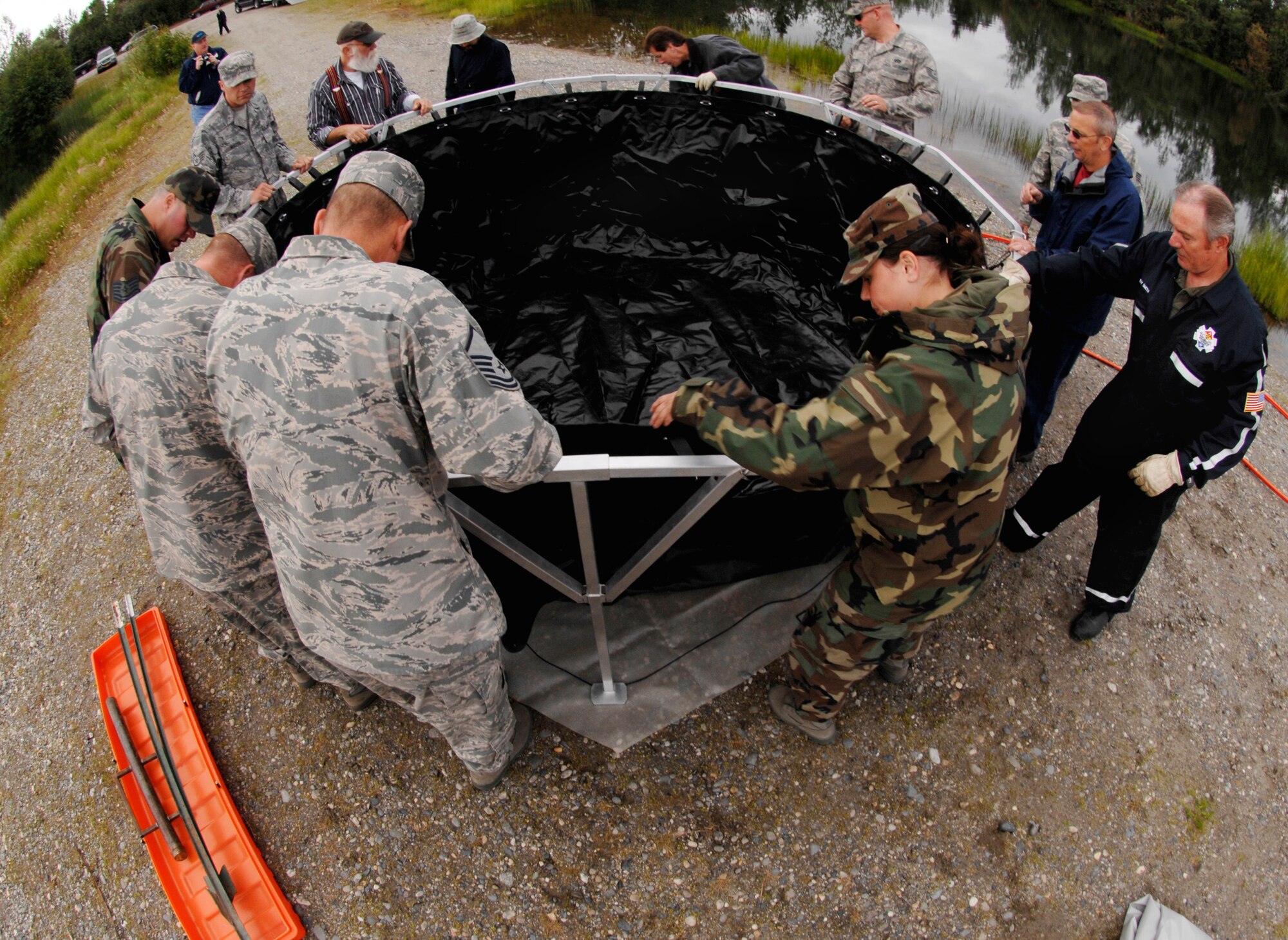 Members of the 354th Civil Engineer Squadron, U.S Navy Supervisor of Salvage Team, Defence Energy Support Center, and the Spectra Tech and Ensafe Corporations assemble a fast tank in preparation for a oil and light fuels spill water contamination clean-up exercise July 23, 2008 at Eielson Air Force Base, Alaska . A fast tank is a collection point where any oil and light fuel that has been cleaned out of water is placed. This exercise is an annual requirement based on the Oil Pollution Act of 1990. (U.S Air Force Photo by Tech Sgt. Eric T. Sheler)