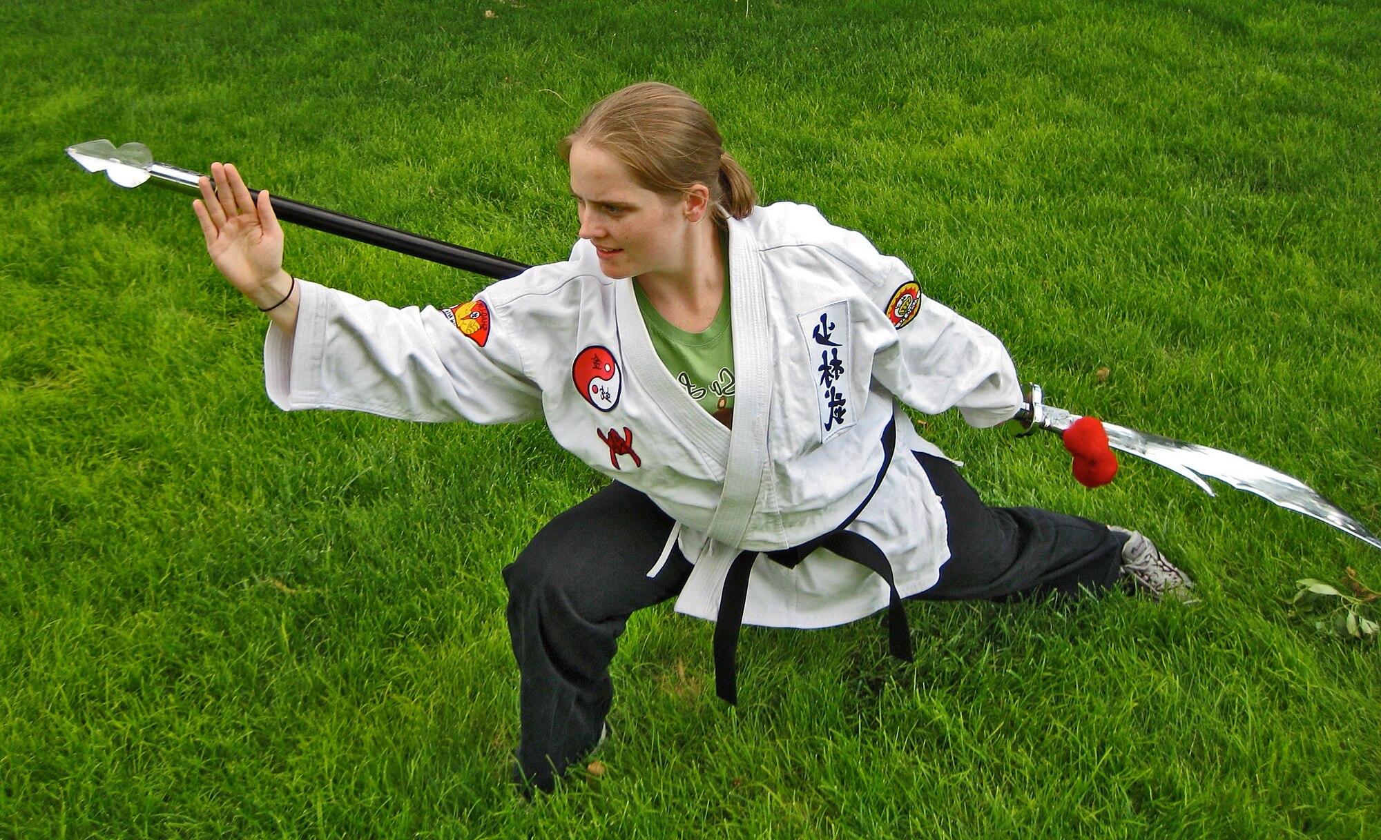 Senior Airman Marie R. Warren, 58th Maintenance Squadron, practices a Kung Fu move with a weapon called a Kwan Tao.  Photo by Matthew Dosanjh