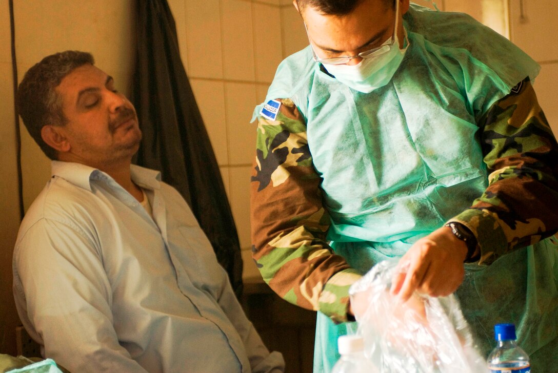 Capt. Federico Antonio Gomez, of El Salvador's Cuscatlan Battalion, prepares for a dental exam during a medical activity held by American and Salvadoran doctors at the Jameer clinic in the Zuwarijat district of Kut, Iraq, July 31, 2008. U.S. Army photo by Sgt. Daniel T. West, 41st Fires Brigade 