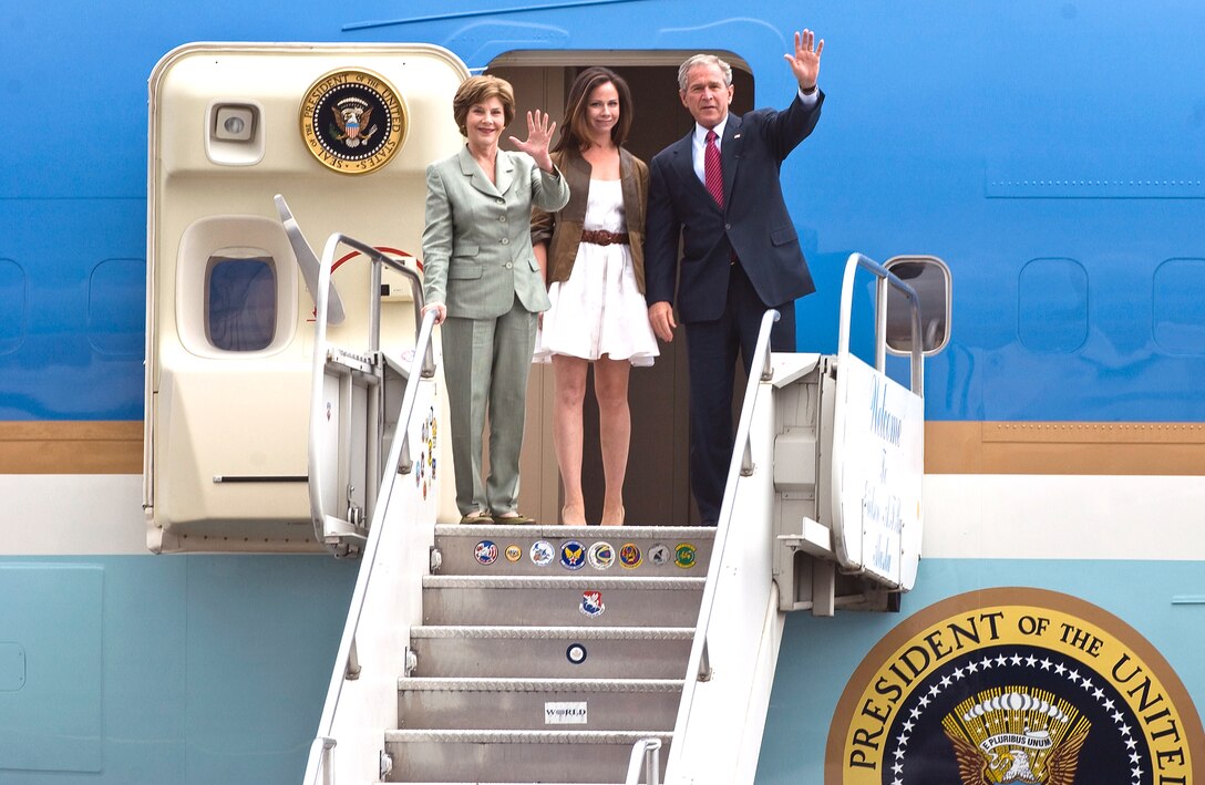 First lady Laura Bush, daughter Barbara and President George W. Bush  wave as they exit Air Force One upon their arrival at Eielson Air Force Base, Alaska, Aug. 4, 2008. The president made a short stop to the base on his way to the 2008 Olympic Games being held in Beijing, China. During his visit he spoke to a crowd of more than 2,000 military personnel and took time to greet and thank individual servicemembers. 