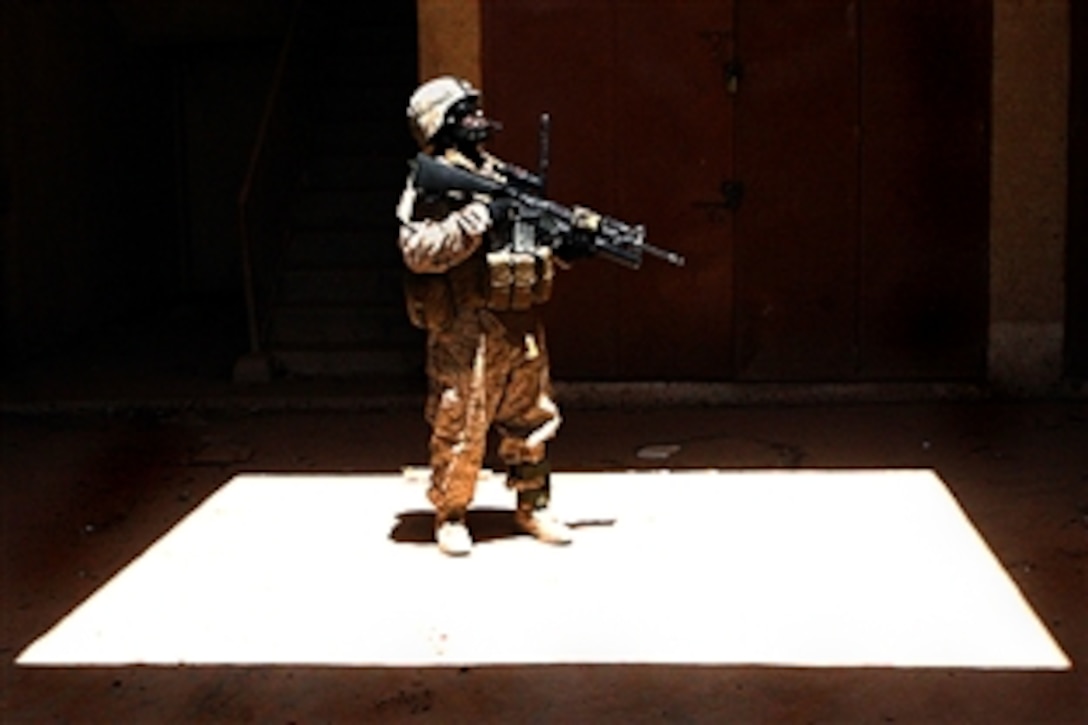 U.S. Marine Sgt. Louis Pearson explores an abandoned building in Husaybah, Iraq, July 23, 2008. Pearson is assigned to the Jump Platoon of Task Force 2nd Battalion, 2nd Marine Regiment. The platoon conducts auxiliary missions, such as route reconnaissance, smuggler searches and contraband checks. U.S. Marine Corps photo by Lance Cpl. Joshua Murray