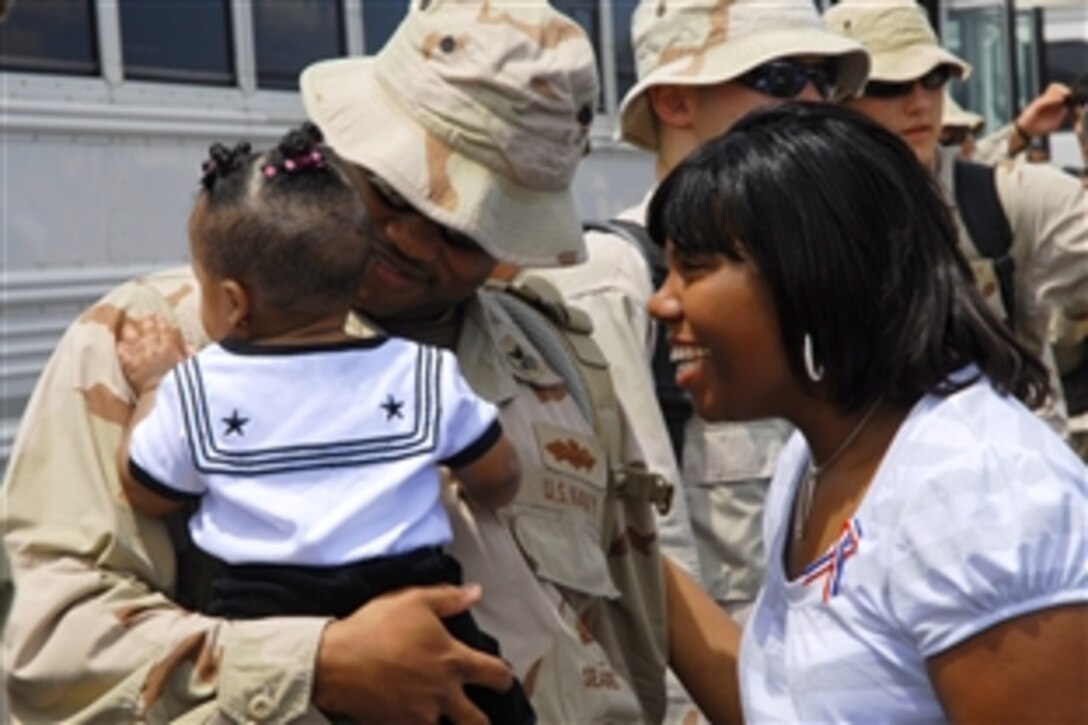 A U.S. Navy Seabee greets his family as he returns from the Naval Construction Battalion Center in Gulfport, Miss., Aug. 4, 2008, following a six-month deployment. The Seabees are assigned to the U.S. Naval Mobile Construction Battalion 74.