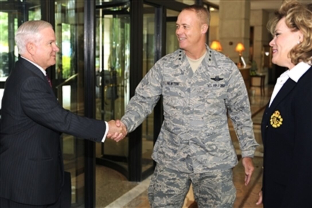 U.S. Defense Secretary Robert M. Gates greets Air Force Lt. Gen. Richard Y. Newton III, deputy chief of staff of manpower and personnel, and his wife, Jody, during the Air Force's Senior Leader Orientation Course in Washington, Aug. 5, 2008. 