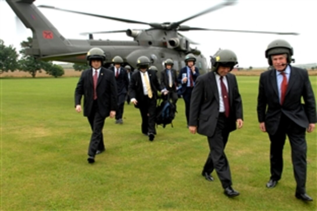 Deputy Chief of Defense Staff of Equipment Capability British Lt. Gen. Andrew Figgures, far right, leads Vice Chairman of the Joint Chiefs of Staff U.S. Marine Gen. James E. Cartwright, second from right, off a Royal Air Force helicopter in Porton Down, England, Aug. 5, 2008. Cartwright traveled to England to meet with his counterparts and receive briefings on operations. 