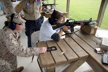 Sergeant Kimberly McBriar, a recruiter from Recruiting Substation Janesville, Recruiting Station Milwaukee, observes the firing techniques of Ross Kramer, a poolee from Janesville, Wis., during a live fire range with the AR-15 rifle August 6 at the Stone Bank Sportsman's Club in Oconomowoc, Wis.  This pool function allowed poolees to learn about the AR-15, the civilian version of the M-16 A2 service rifle, to include weapons safety, weapons handling, trigger control, breath control and to become familiar with a weapon similar to what they will be firing in boot camp.