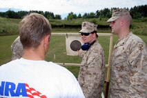 Sergeant Kimberly McBriar, a recruiter from Recruiting Substation Janesville, Recruiting Station Milwaukee, explains grouping to Ross Kramer, a poolee from the RSS, and how to improve his shooting.  Poolees from nine of the 13 recruiting substations under RS Milwaukee fire the AR-15 rifle during a familiarization rifle range August 4-7 at the Stone Bank Sportsman's Club in Oconomowoc, Wis.  This pool function allowed poolees to learn about the AR-15, the civilian version of the M-16 A2 service rifle, to include weapons safety, weapons handling, trigger control, breath control and to become familiar with a weapon similar to what they will be firing in boot camp.