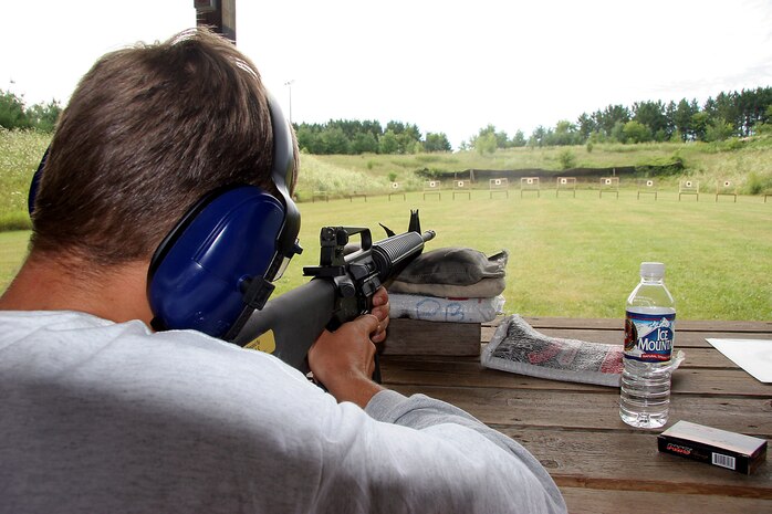 Poolee Ross Kross, a poolee from Recruting Substation Janesville, Recruiting Station Milwaukee, fires the AR-15 rifle during a familiarization rifle range August 6 at the Stone Bank Sportsman's Club in Oconomowoc, Wis.  This pool function allowed poolees to learn about the AR-15, the civilian version of the M-16 A2 service rifle, to include weapons safety, weapons handling, trigger control, breath control and to become familiar with a weapon similar to what they will be firing in boot camp.