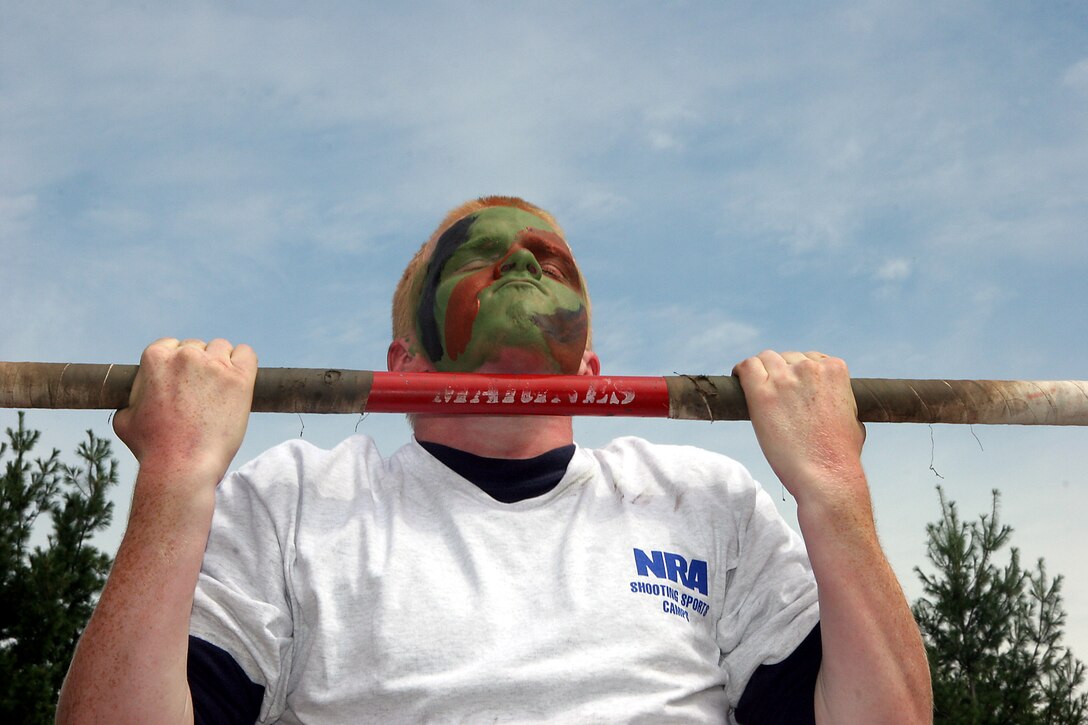 Paul Brandonberg, a poolee with Recruiting Substation Janesville, pumps out 20 pull-ups during a partial Initial Strength Test following a live fire rifle range with the AR-15 at Stone Bank Sportsman's Club in Oconomowoc, Wis., August 6.