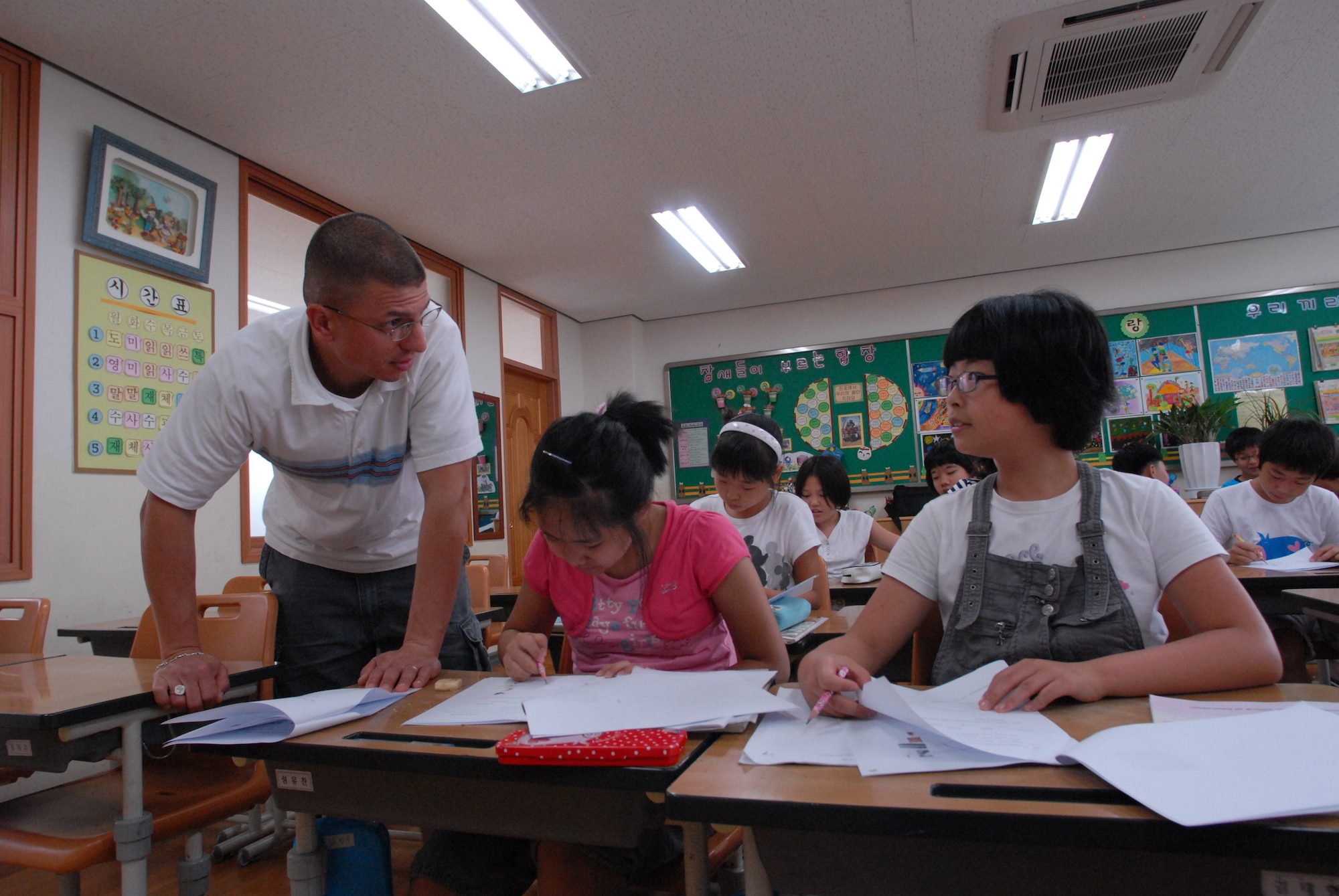 KUNSAN AIR BASE, Republic of Korea— Technical Sergeant Scott Ibanez, 8th Maintenance Squadron, answers students questions for the Kunsan-Sponsored English Camp at the Jinp'yo Elementary School, Gunsan City July 30. 15 Airmen Volunteered to help teach More Than 60 elementary and middle grade Korean students that participated in the English Camp.(US Air Force Photo By: Senior Airmen Angela Ruiz)