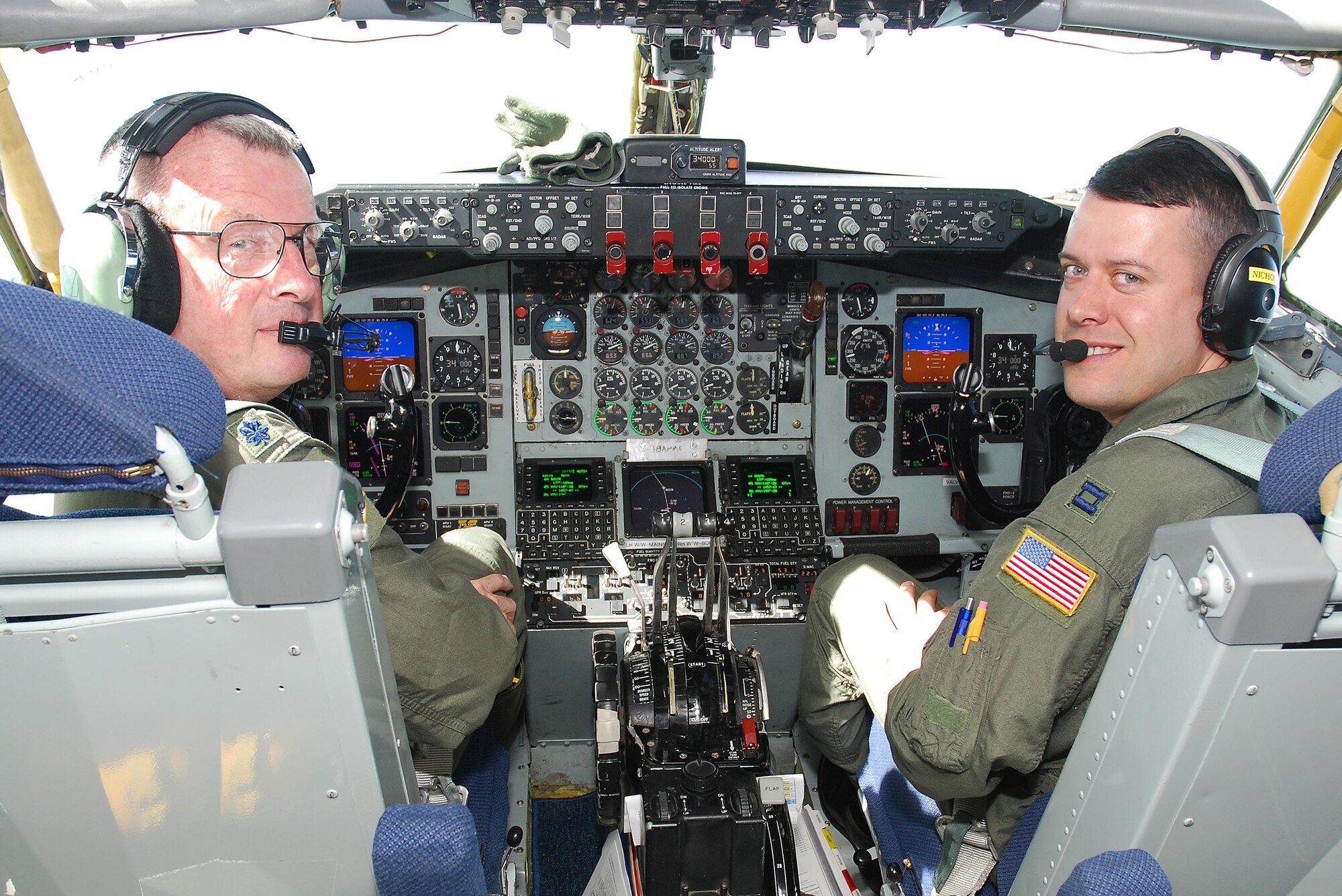 Lt. Col. Robert Nicholson (left) of Air Force Reserve Command’s Detachment 2, Fourth Air Force, March Air Reserve Base, and his oldest son, Capt. David Nicholson of the Michigan Air National Guard’s 127th Air Refueling Group, share a moment during Colonel Nicholson’s final KC-135 flight July 22, at Selfridge Air National Guard Base, Mich. The occasion was Col. Nicholson’s final KC-135 flight before his retirement after 37 years of service. The Air Force Reserve and the Air National Guard had to approve the training mission in order for the father and son to fly together. (U.S. Air Force photo)