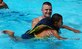 Air Force Capt. Dennis Spencer, a physician assistant at Joint Task Force-Bravo, plays with a child in the pool during a kids' day at Soto Cano Air Base, Honduras. More than 50 boys from the Hogar de Ninos Nazareth Orphanage in Comayagua came to the base Aug. 2 for a day of fun and activities.