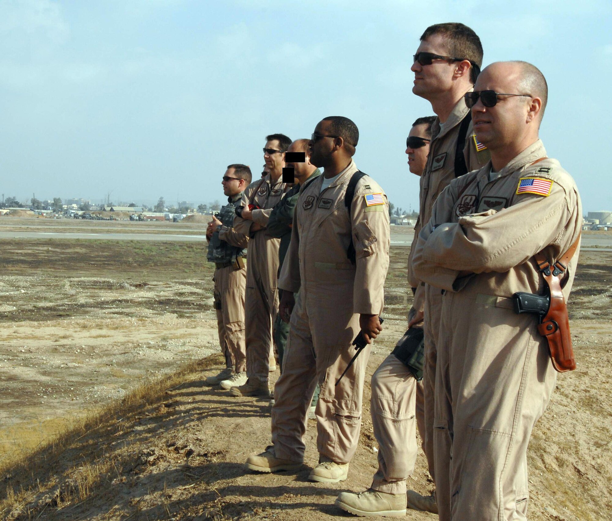 U.S. Air Force instructor pilots are working with Iraqi air force pilots to build the Iraqi air force flight training program at Kirkuk, Iraq. From far to near are: U.S. Air Force Maj. Joseph Markusfeld, Vance AFB, Okla.; U.S. Air Force Lt. Col. Scott Voskovitch, Whiteman AFB, Mo.; Iraqi air force Maj. Abdul; Iraqi air force Lt. Col. “K”; U.S. Air Force Capt. Leon Butler, Vance AFB; U.S. Air Force Maj. Scott McCartt, Columbus AFB, Miss.; U.S. Air Force Capt. Brian Riggle, Vance AFB; and U.S. Air Force Capt. Chris Duffett, Columbus AFB. Iraqi instructors’ names were changed and faces covered for security reasons. (U.S. Air Force photo)