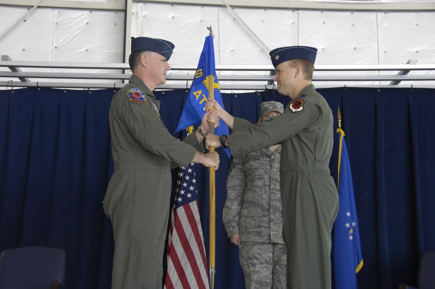 CREECH AFB, Nev. – Lieutenant Colonel Christopher Gough, 42d Attack Squadron commander, accepts command from Col. William Brandt, 432d Operations Group commander, during a change of command ceremony here Aug. 1. The mission of the 42d Attack Squadron is to train combat ready MQ-9 Reaper aircrews, develop operational tactics, and conduct combat operations in support of combatant commanders worldwide. The 42d ATKS stood up November 2006, and established the first and only MQ-9 Formal Training Unit within three months, producing the first group of fully mission capable MQ-9 crews within six months and deployed the Reaper in support or Operation Enduring Freedom more than one year ahead of schedule. (U.S. Air Force photo/Staff Sgt. Kenny Kennemer)