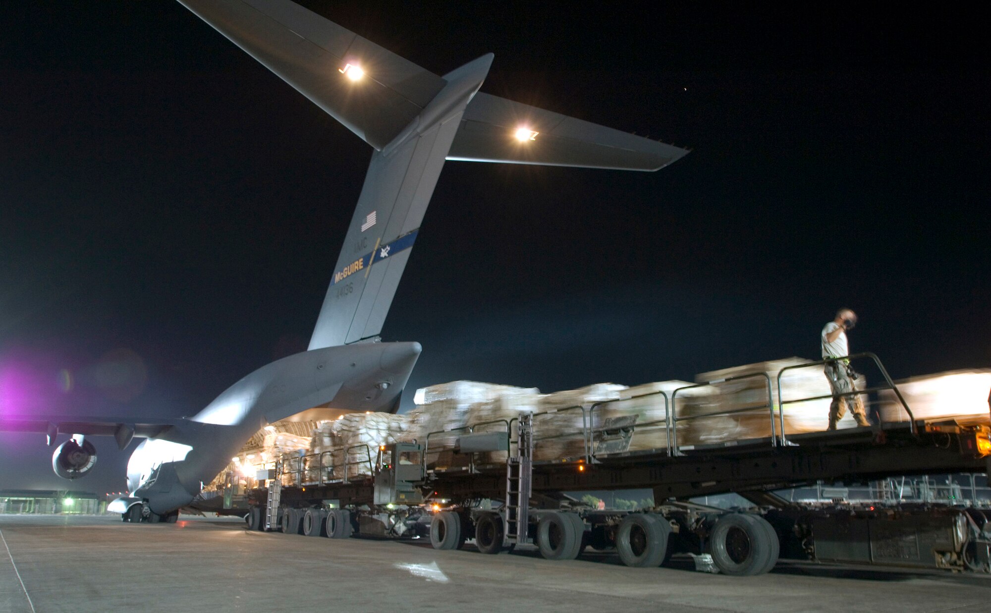Airmen load more than 56,000 pounds of cargo from three Tunner 60K loaders onto a C-17 Globemaster III Aug. 3 at Joint Base Balad, Iraq.  More than 950 cargo aircraft, 12,000 tons of cargo and 19,000 passengers are processed each month, making it the busiest aerial port operation in the Department of Defense. This C-17 is deployed from the 305th Air Mobility Wing at McGuire Air Force Base, N.J. (U.S. Air Force photo/Airman 1st Class Jason Epley) 