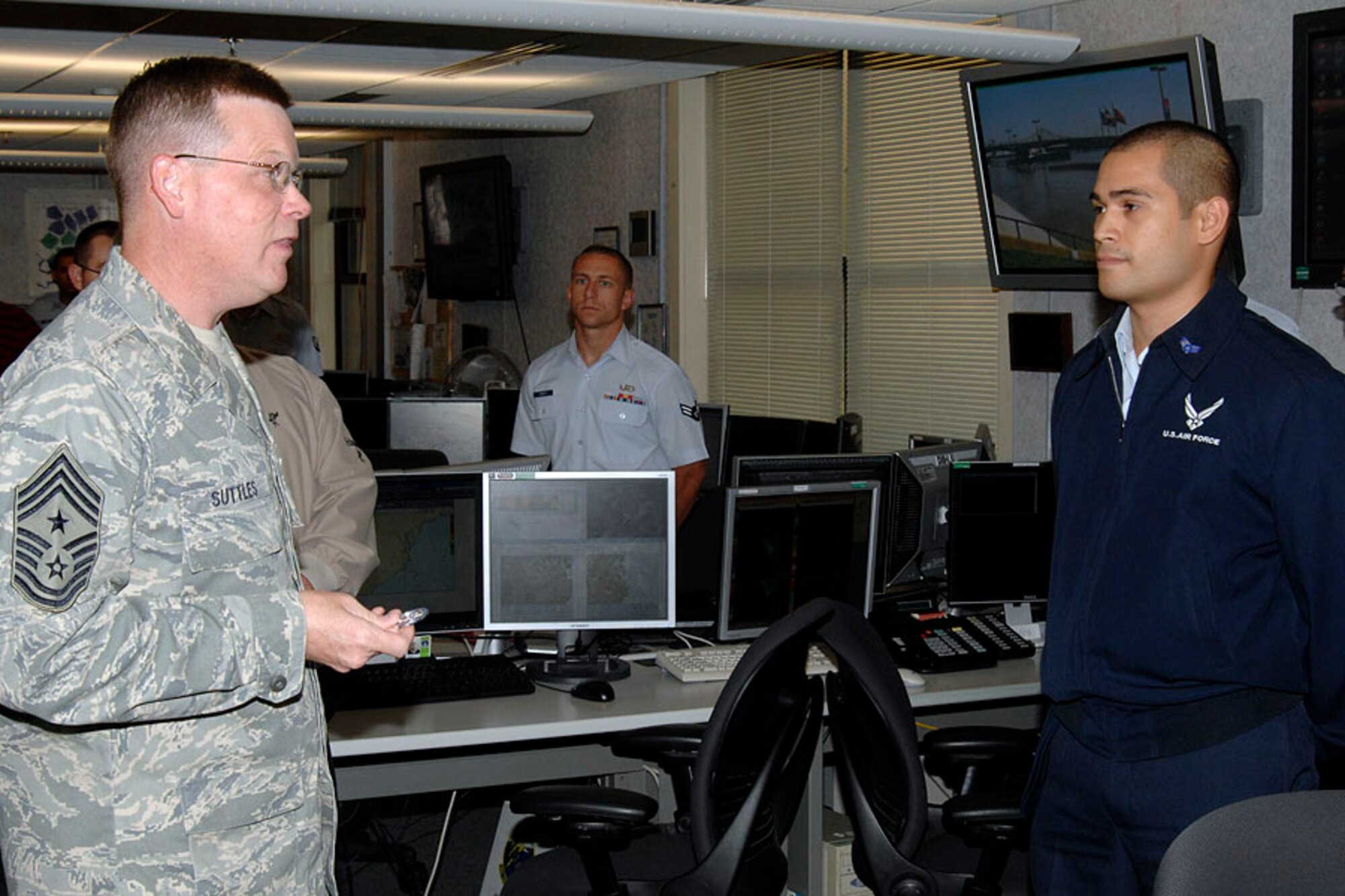 SCOTT AIR FORCE BASE, Ill. -- Chief Master Sgt. James Suttles, 375th Airlift Wing command chief, presents the Wingman’s Coin to Senior Airman John Apple, 15th Operational Weather Squadron weather forecaster, for his display of selflessness in helping another Airman move out of the dorms before separating from the military. 
(US Air Force photo/Senior Airman Jonathan Lovelady)
