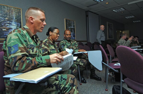Tech. Sgt.'s Glen Pearson (far left), Alicia Bowens and Milton Willhight prepare to give a group presentation while attending a Noncommissioned Officer Leadership Development Program course at McConnell Air Force Base, Kan. The course, designed to help mid-level NCOs develop leadership, began on Aug. 4 and is scheduled to end on Aug. 15. Sergeant's Pearson and Willhight are assigned to the 931st Aircraft Maintenance Squadron.  Sergeant Bowens is assigned to the 931st Communication and Information Systems Flight.  (U.S. Air Force Photo/Tech. Sgt. Jason Schaap)