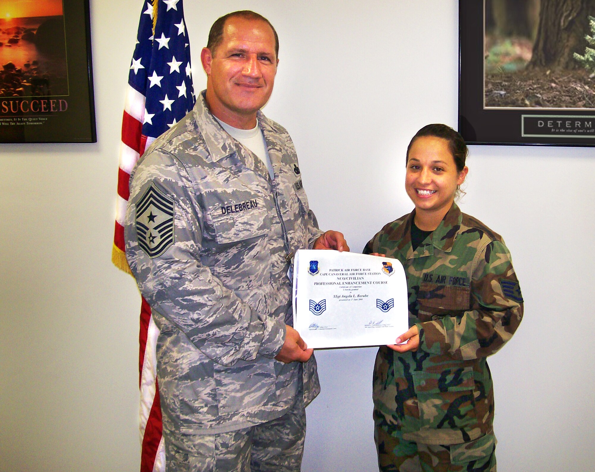 PATRICK AIR FORCE BASE, Fla. -- Staff Sgt. Angela L. Berube, a dietary therapy journeyman, became the first 920th Rescue Wing member to attend the 45th Space Wing's Professional Enhancement Course (PEC) after her graduation June 27. Wing Command Chief Master Sgt. Gerald Delebreau, also pictured, enouraged all Reserve junior NCOs to attend the four-day class, which covers a range of subjects such as ethics, mentoring, team-building and motivation, fitness, career progression, bullet-statement writing, air-expeditionary force, thrift savings plan, counseling and the seven habits of highly effective people, just to name a few. Sergeant Berube is a member of the 920th Aeromedical Staging Squadron here. (U.S. Air Force photo/Master Sgt. Jonathan Green)