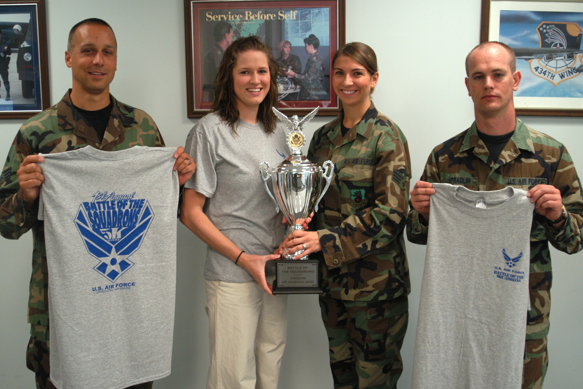 GRISSOM AIR RESERVE BASE, Ind., -- Airmen from the 434th Aerospace Medicine Squadron are hosting a 5k run/walk in September. The winner of the race will receive a trophy that will be kept at their unit for the year. Participants will also receive a T-shirt. Displaying the trophy and T-shirt's that will given out are from left to right are Senior Airmen Clayton Duncan, Erica Suchousky, Eilleen Smith and Tech. Sgt. Damon Spradlin, all are members 434th AMDS,  (U.S. Air Force photo/Senior Airman Carl Berry)
