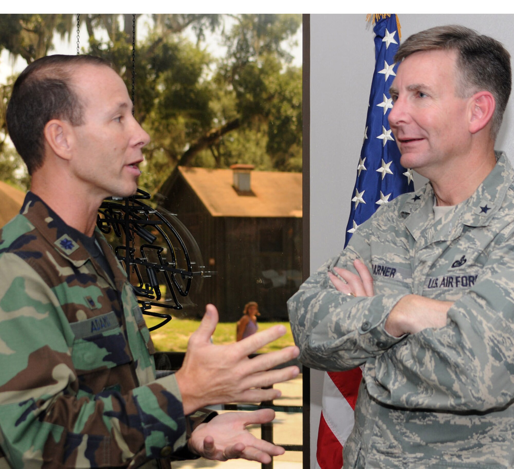 Lt. Col. Ray Adams, left, 81st Communications Squadron, talks with Brig. Gen. David Warner, guest speaker for the Armed Forces Communications and Electronics Association luncheon, July 30 at the Kat-rina Kantina.  The general is the communications and information director and chief information officer at Air Force Space Command headquarters, Peterson Air Force Base, Colo.  (U.S. Air Force photo by Kemberly Groue)
