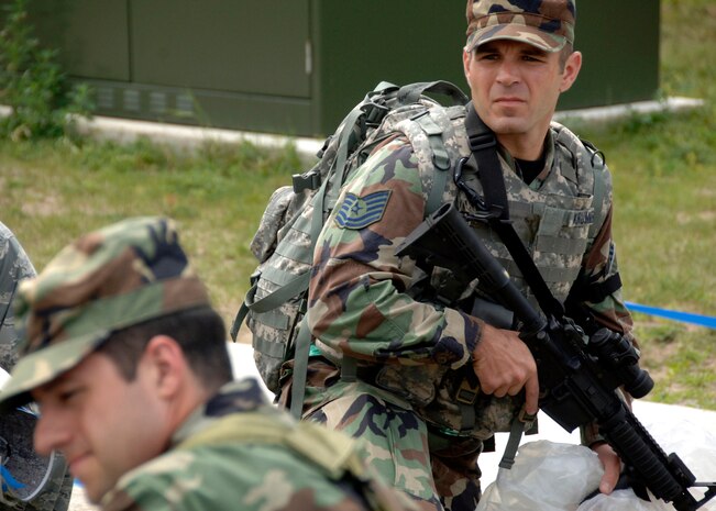 Tech. Sgt. Jeremy Krummrich maintains security in an overwatch position while Airmen "bug-out" from the installation control center and emergency operations center at a simulated air base in East Asia Aug. 5. Headquarters inspectors are evaluating the 437th and 315th Airlift Wings' capability to generate aircraft, deploy Airmen and cargo and employ from a forward location in support of global military operations. Sergeant Krummrich is assigned to the 437th Security Forces Squadron.(U.S. Air Force photo/Airman 1st Class Timothy Taylor)