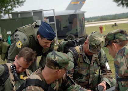 Col. Joseph Mancy, briefs the installation control center and emergency operations center Airmen after they performed a successful "bug-out" drill at a simulated forward deployed location in Southeast Asia Aug. 5. "Bug-out" drills are conducted to demonstrate the effectiveness of building occupants to evacuate quickly from a building as quickly and safely as possible. Headquarters inspectors are evaluating the 437th and 315th Airlift Wings' capability to generate aircraft, deploy Airmen and cargo and employ from a forward location in support of global military operations. Colonel Mancy is the 805th Air Expeditionary Wing commander. (U.S. Air Force photo/Airman 1st Class Timothy Taylor)