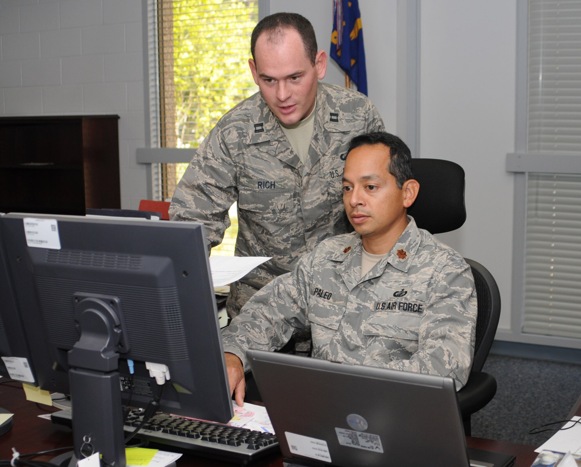 Capt. Jeffery Rich, left, briefs Maj. Robert Paleo, the 81st Comptroller Squadron’s new commander.  Major Paleo previously served as the 47th Comptroller Squadron commander at Laughlin AFB, Texas.  (U.S. Air Force photo by Kemberly Groue)