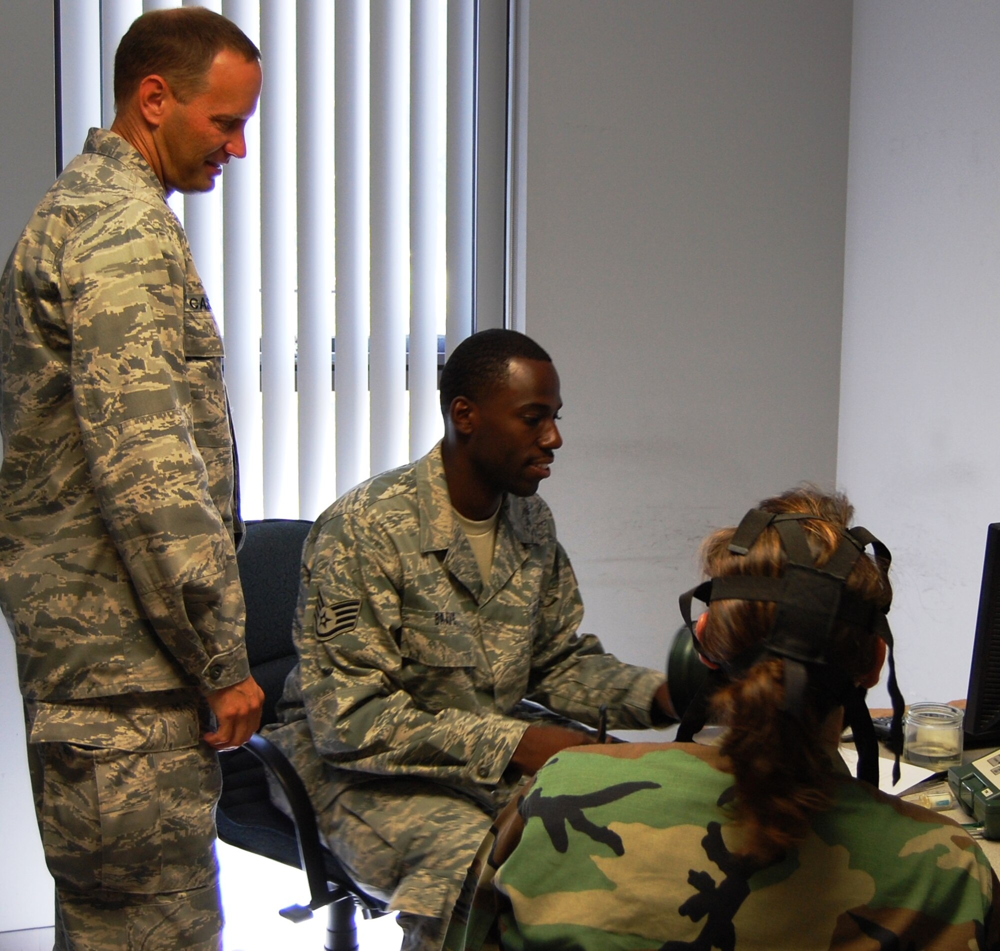 Lt. Col. Brian Casleton, standing, new 81st Aerospace Medicine Squadron commander, watches Staff Sgt. Mondlie Brave of his unit’s bioenvironmental engineering flight do a gas mask test on Tech. Sgt. Heather West, 53rd Weather Reconnaissance Squadron.   Prior to his current assignment, Colonel Casleton commanded the 59th Laboratory Squadron’s clinical laboratory flight at Lackland AFB, Texas.  (U.S. Air Force photo by Steve Pivnick)