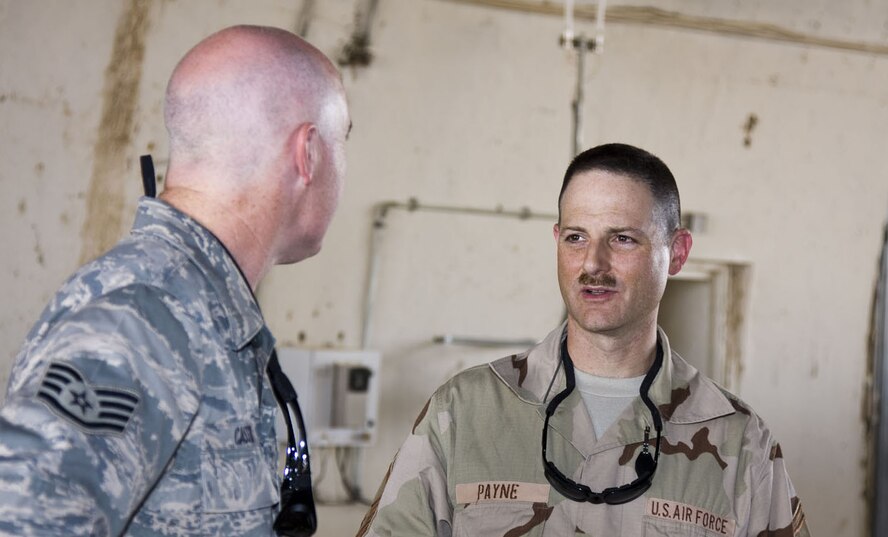 SEYMOUR JOHNSON AIR FORCE BASE, N.C.-- Senior Master Sgt. Bryan Payne, a Reservist with the 916th Communications Squadron talks with Staff Sgt. Hans Pugh,of the 332nd Expeditionary Communications Squadron, about replacing and testing a Proxim Tsunami for the Flightlight Wireless LAN project. Both Airmen are currently stationed in Balad, Iraq.