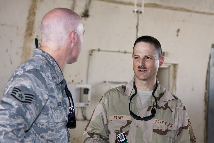 SEYMOUR JOHNSON AIR FORCE BASE, N.C.-- Senior Master Sgt. Bryan Payne, a Reservist with the 916th Communications Squadron talks with Staff Sgt. Hans Pugh,of the 332nd Expeditionary Communications Squadron, about replacing and testing a Proxim Tsunami for the Flightlight Wireless LAN project. Both Airmen are currently stationed in Balad, Iraq.