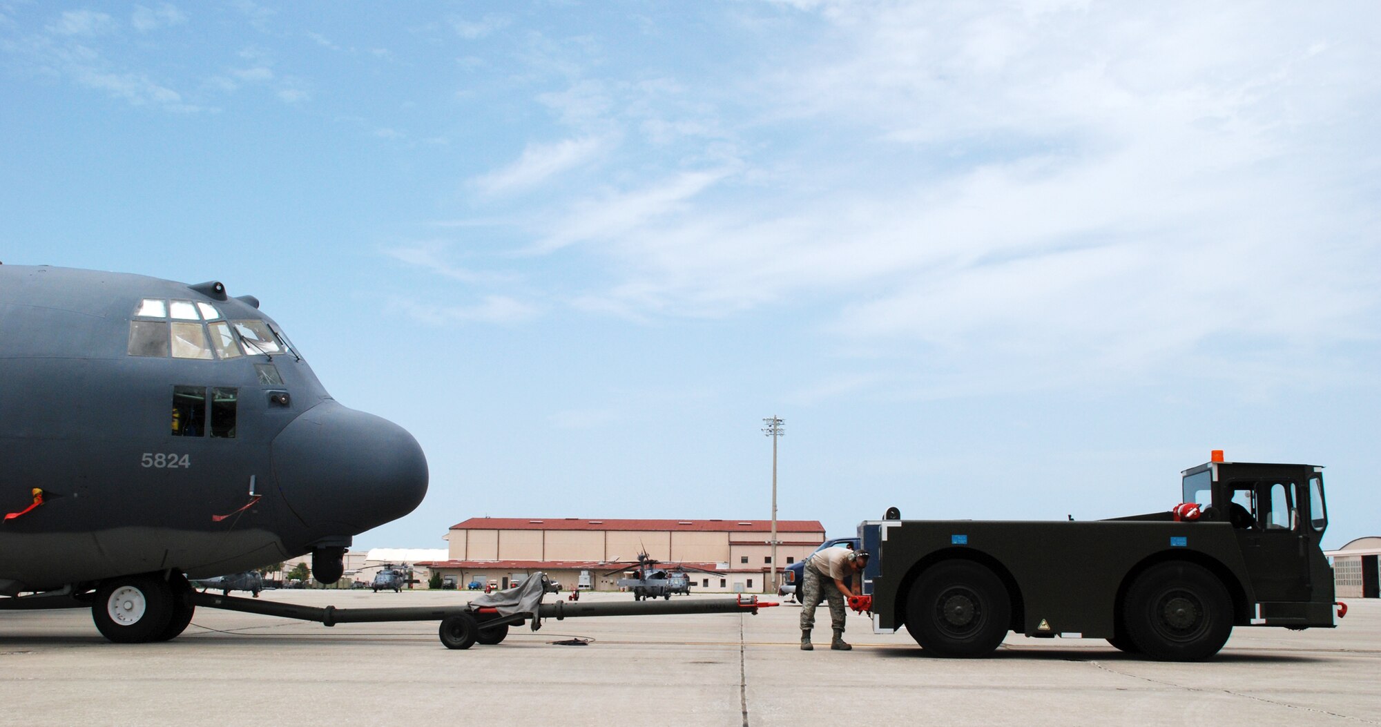 An HC-130 Hercules is towed back onto the flightline at Patrick Air Force Base after 920th Rescue Wing maintainers completed servicing a strut on the aircraft.(U.S. Air Force photo/Staff Sgt. Heather Kelly)