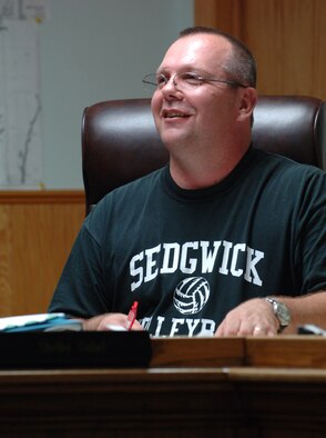 Master Sgt. Shelby Gobel shares a smile with fellow planning commission members during a meeting in his hometown of Sedgwick, Kan. Sergeant Gobel is scheduled to retire from the Air Force Reserve on Aug. 9, more than two years after a motorcycle accident almost killed him. He joined the planning commission while recovering and waiting for decisions about his future with his civilian employer and his position with the 931st Civil Engineer Squadron. (U.S. Air Force Photo/Tech. Sgt. Jason Schaap)