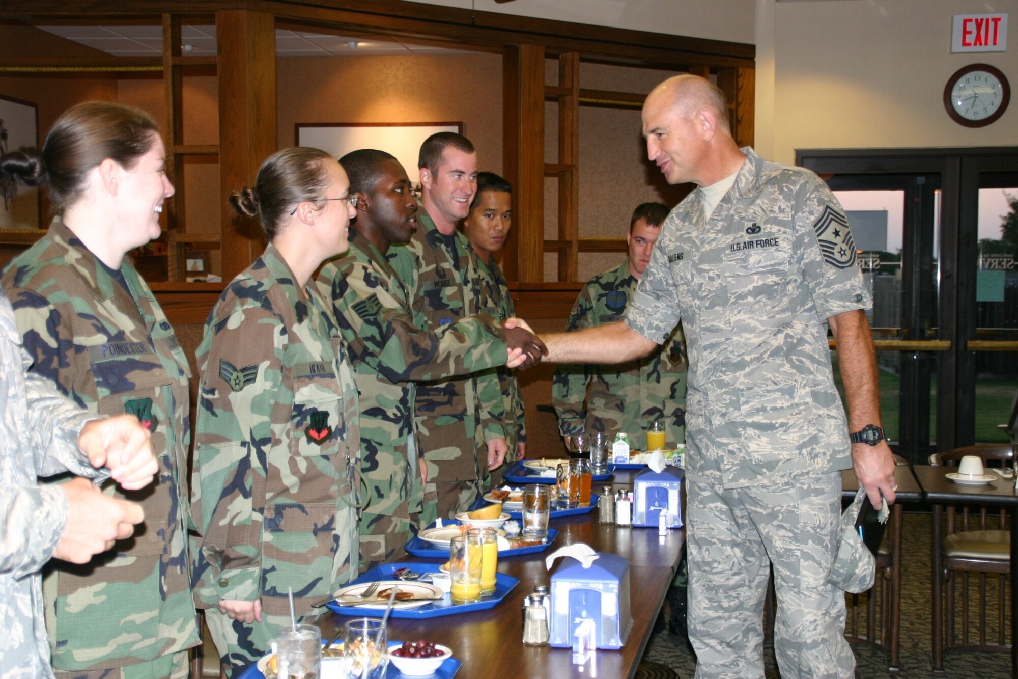 Chief Master Sgt. Stephen C. Sullens, Command Chief, Air Combat Command greets members of the 552nd Air Control Wing at an Airmen’s Breakfast at Vanwey Dining Facility during his visit. Chief Sullens discussed various topics with the Airmen including the new military uniform, physical fitness, deployments and sponsorship. Photo by 2nd Lt. Kinder Blacke.