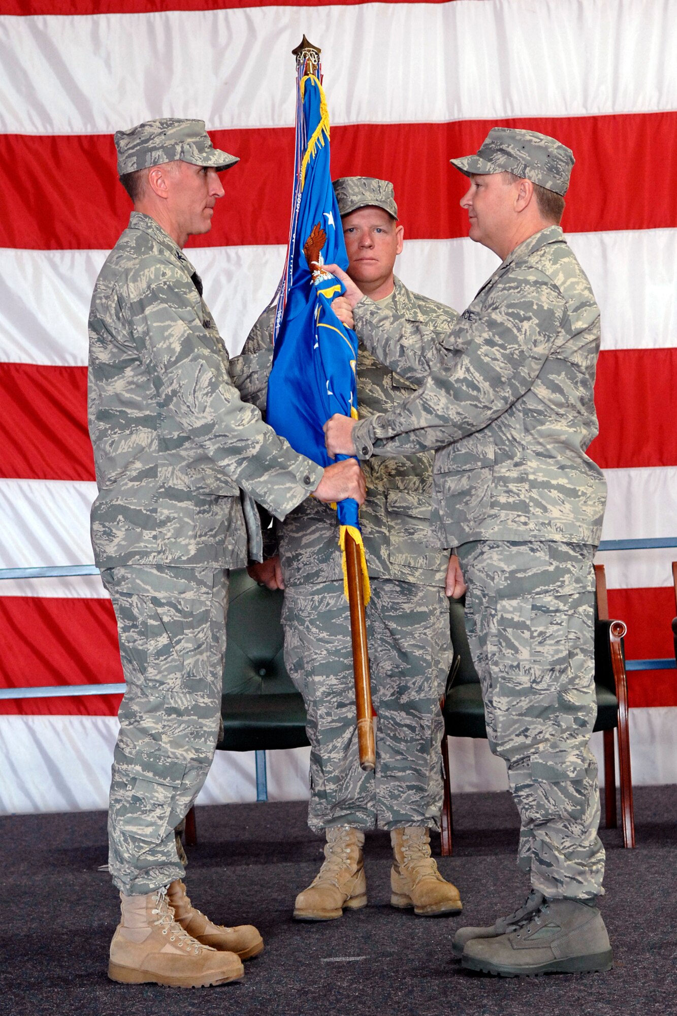 Col. Michael Yuill accepts command of the 28th Mission Support Group from Col. Scott Vander Hamm, 28th Bomb Wing commander, in Dock 33, Aug. 1. The 28 MSG provides all essential base operating support for Ellsworth. Colonel Yuill was previously stationed at Davis-Monthan Air Force Base, Ariz., as the deputy commander of the 612th Air and Space Operations Center. He has more than 3,600 combined flying hours as a command pilot of B-52, T-37, T-38A and B-1B airframes.(U.S. Air Force photo/Senior Airman Marc I. Lane)
