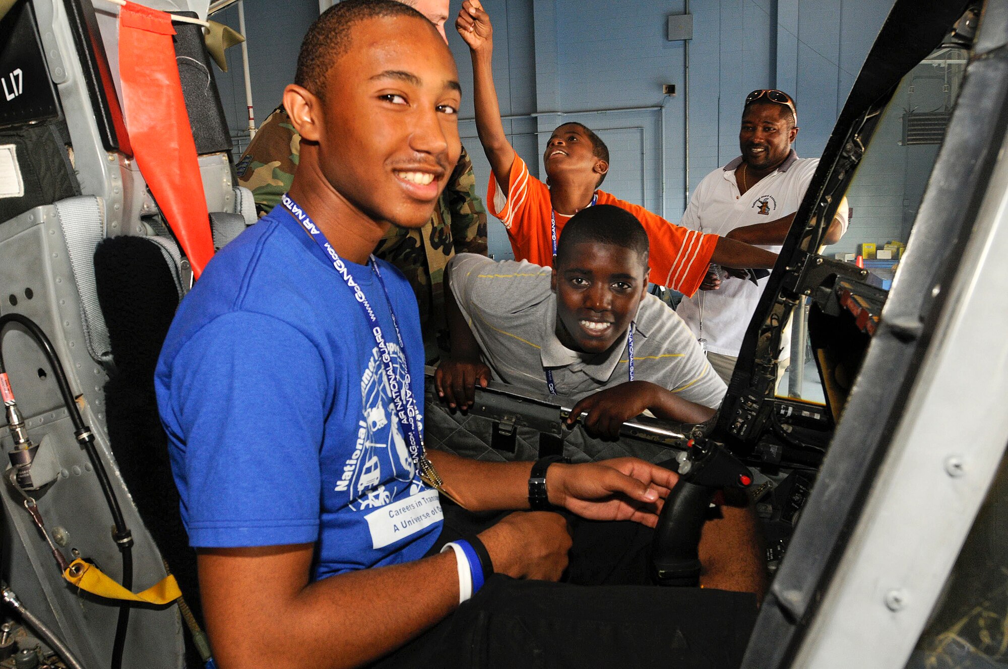Diamante Astellero from the Summer Transportation Institute, Cheney University, Pa. sits in the pilot seat of an A-10 jet while Shane Walker and Edward Shepard, from Young Minds that Soar and Delaware Police Athletic League wait there turn to get into the plane. The 111th Fighter Wing hosted Tuskegee Airman Youth Day on Saturday July 19th.  Young men and women from Greater Philadelphia and Delaware came to ARS Willow Grove to meet Tuskegee Airmen and see up close aircraft such as an A-10, F-16, T-6A and P-3.  