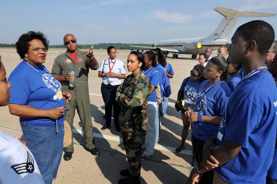 Captain Rich "Sheriff" Peace, from the 100th Fighter Squadron, Montgomery, Alabama gives an F-16 briefing to a group of adults and children from the Summer Transportation Institute, Cheney University, Pa. The 111th Fighter Wing hosted Tuskegee Airman Youth Day on Saturday July 19th.  Young men and women from Greater Philadelphia and Delaware came to the Willow Grove Air Reserve Station to meet Tuskegee Airmen and see up close aircraft such as an A-10, F-16, T-6A and P-3.