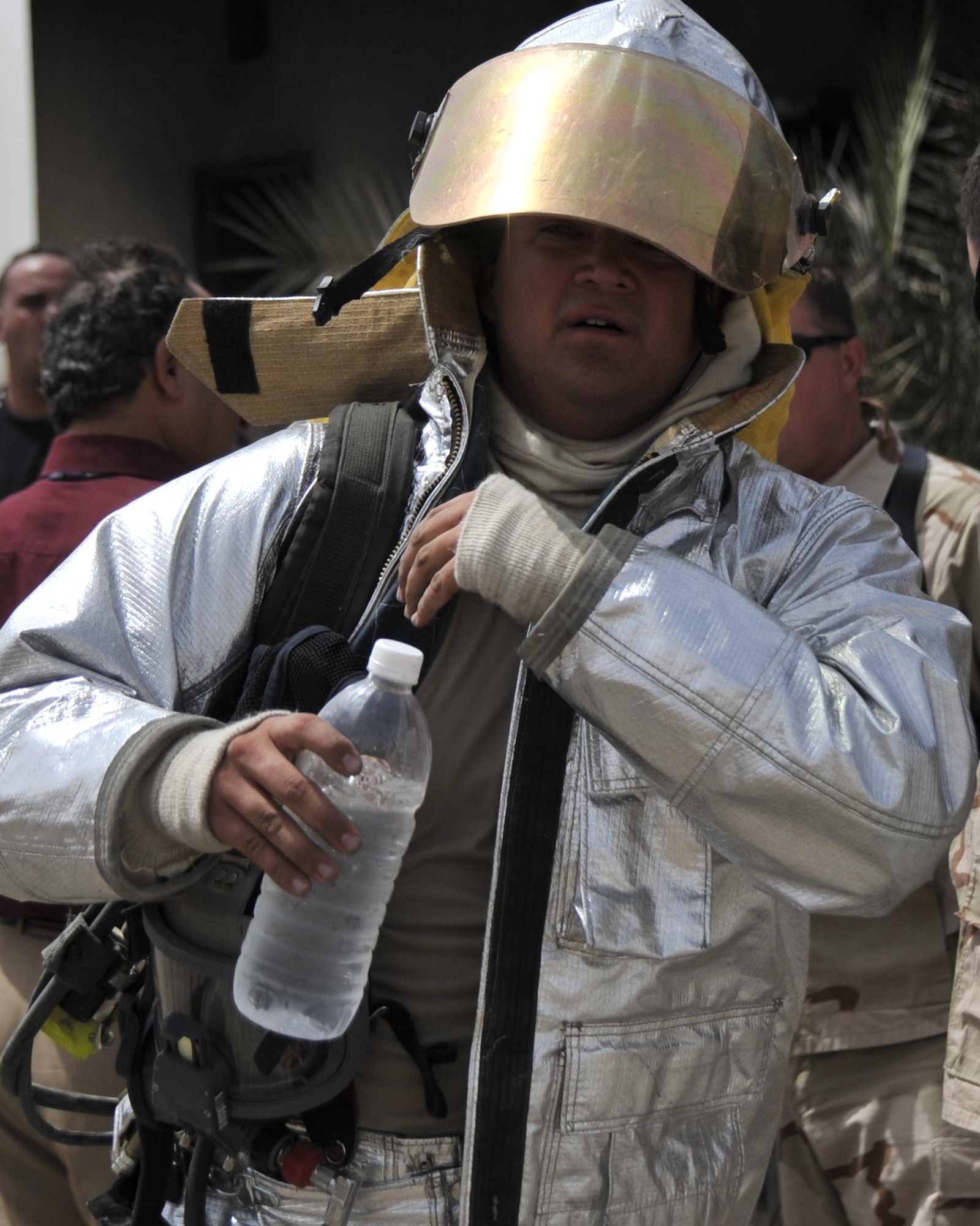 8/5/2008 - BAGHDAD INTERNATIONAL AIRPORT, Iraq ? Staff Sgt. Matthew Dodge, a firefighter with the 447th Expeditionary Civil Engineer Squadron at Sather Air Base, hydrates after an Air Force and Iraqi combined live fire training exercise. Sergeant Dodge is deployed from the Oklahoma Air National Guard where he is assigned to the 137th Airlift Wing in Oklahoma City. (U.S. Air Force Photo by Master Sgt. Brian Davidson)
